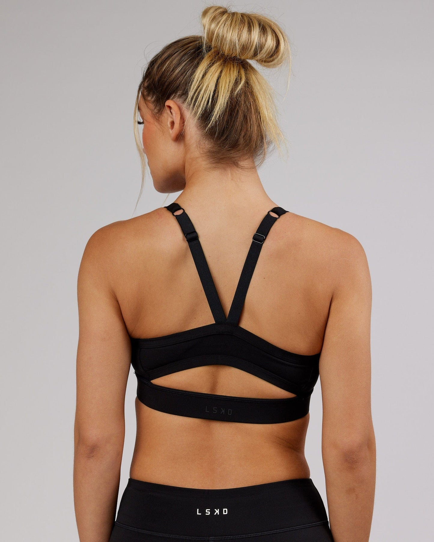 Woman wearing Momentum Sports Bra - Black