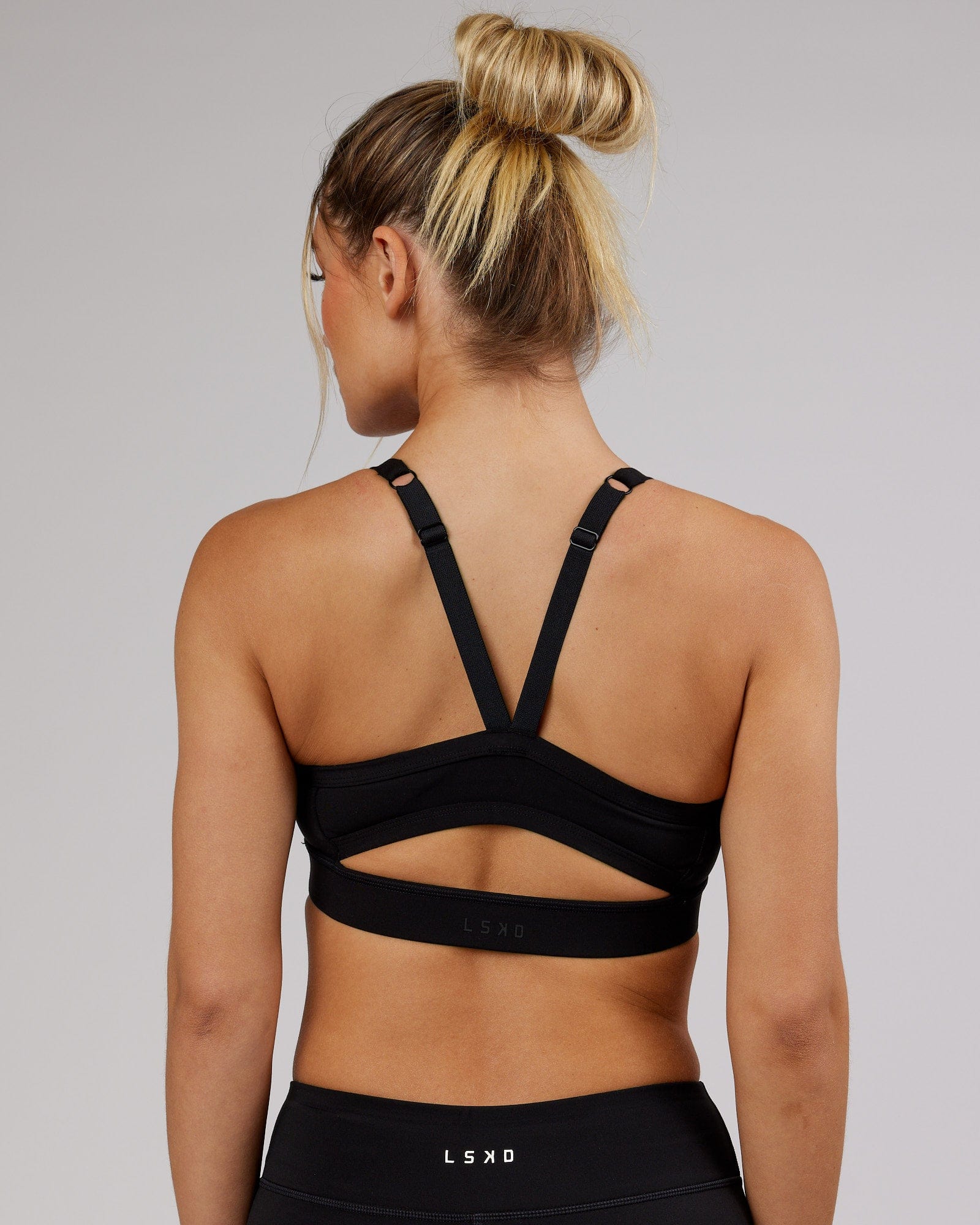 Woman wearing Momentum Sports Bra - Black