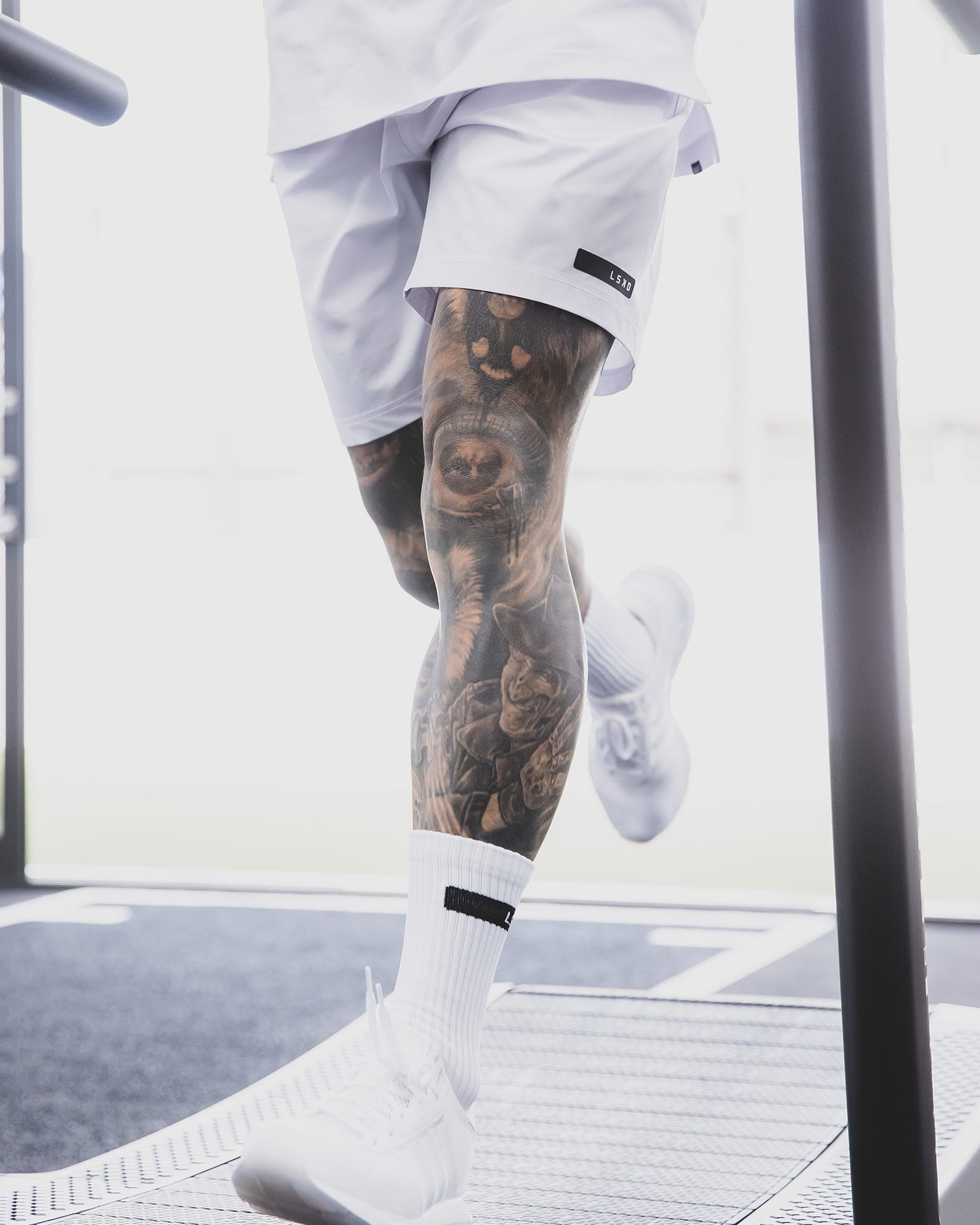 Model wearing LSKD x LM Rep 7" Performance Shorts - White