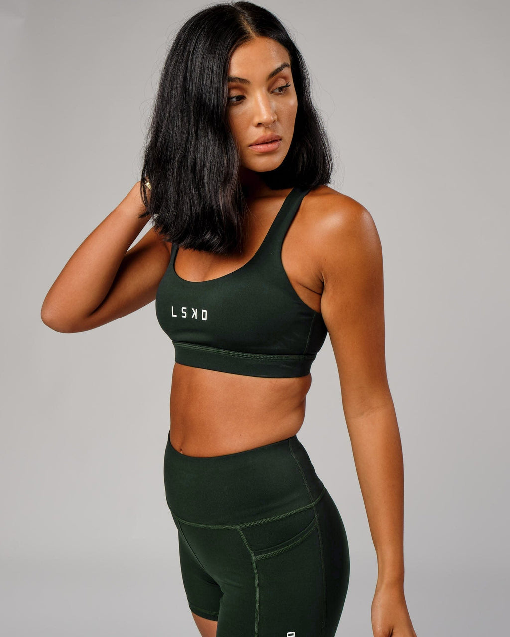 Model wearing Rep Sports Bra Small Logo - Forest