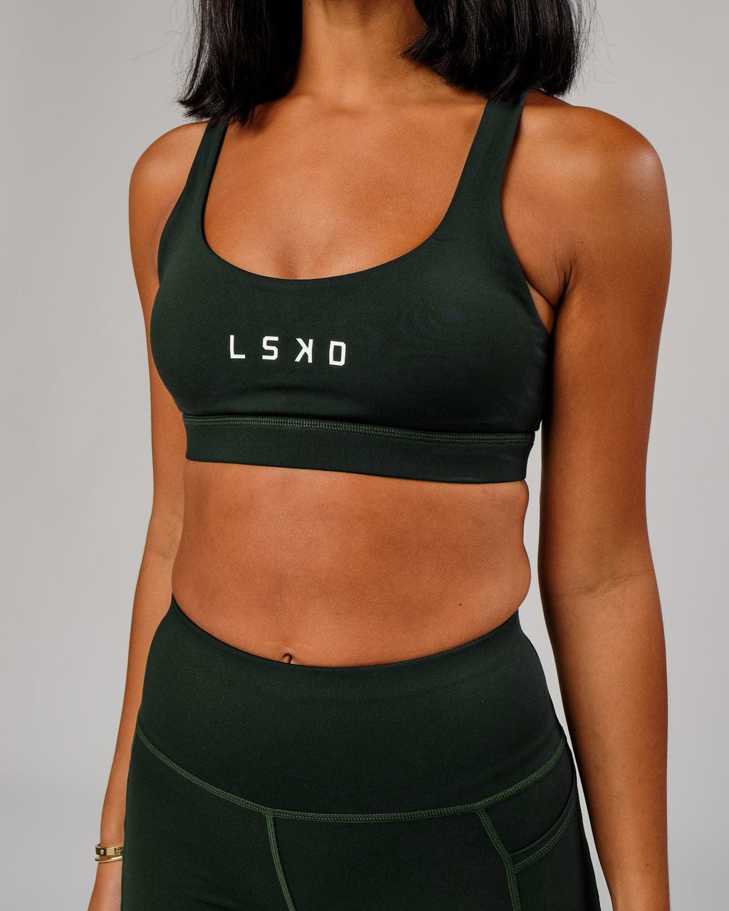 Model wearing Rep Sports Bra Small Logo - Forest