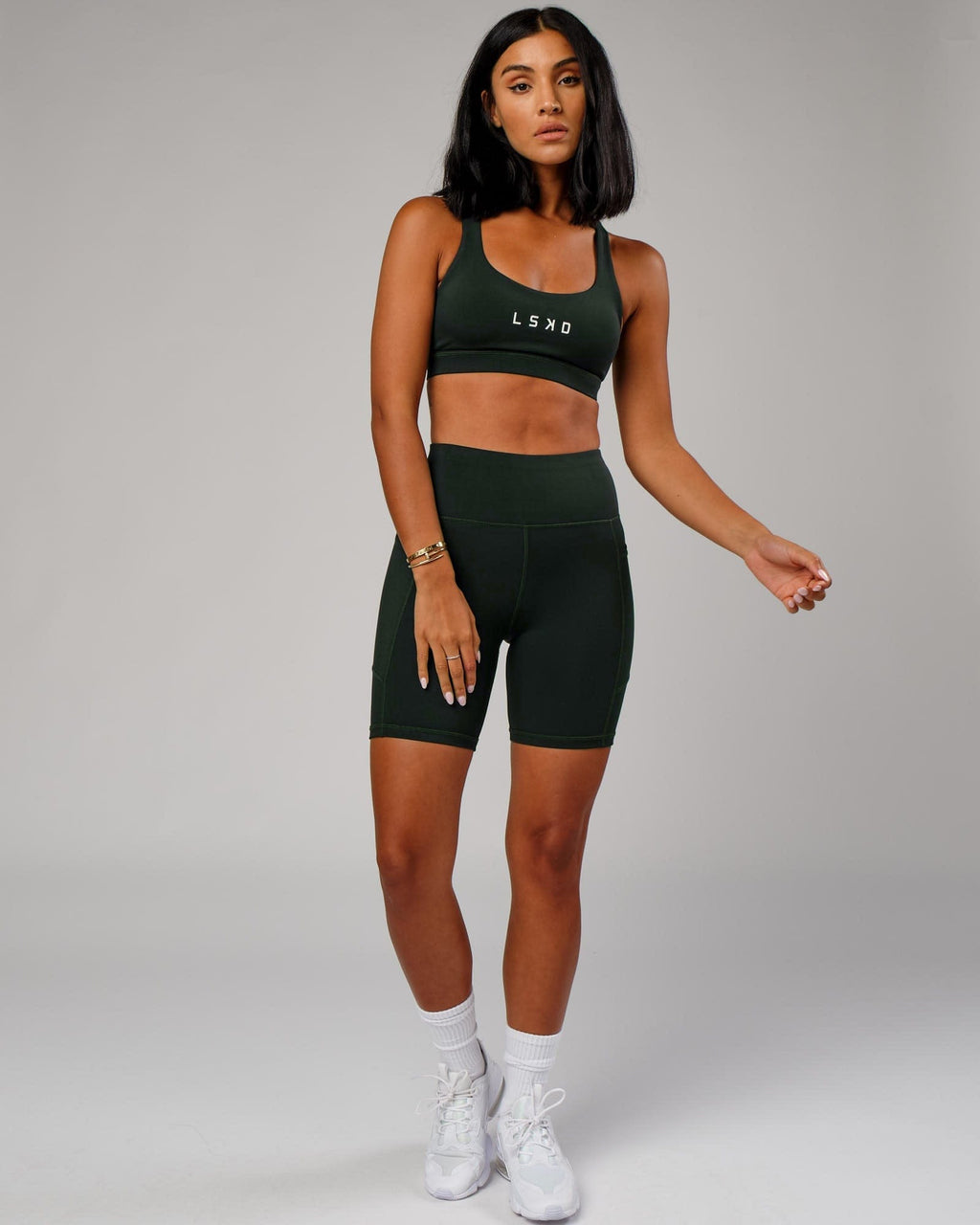 Model wearing Rep Mid Short Tight Small Logo - Forest