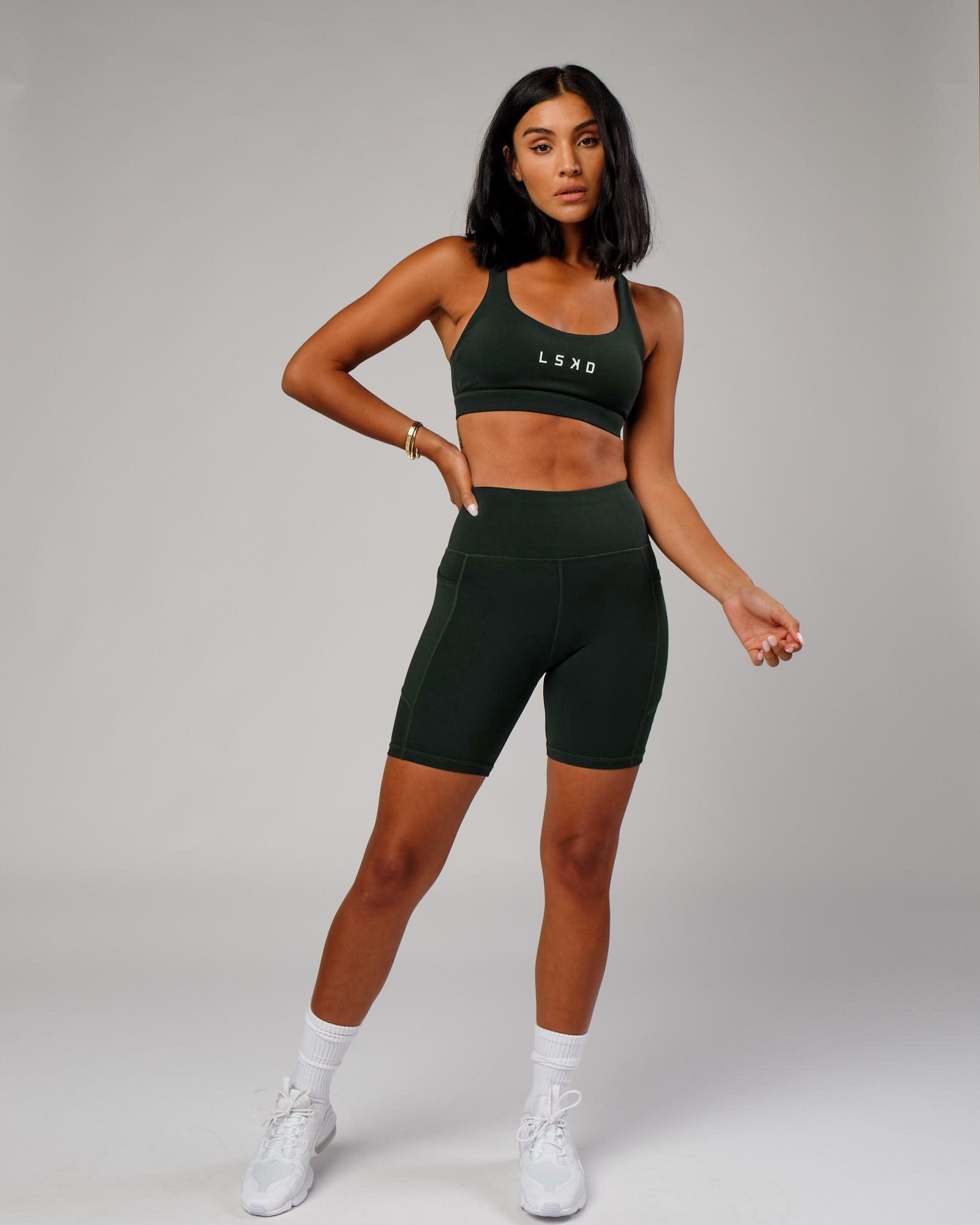 Model wearing Rep Mid Short Tight Small Logo - Forest