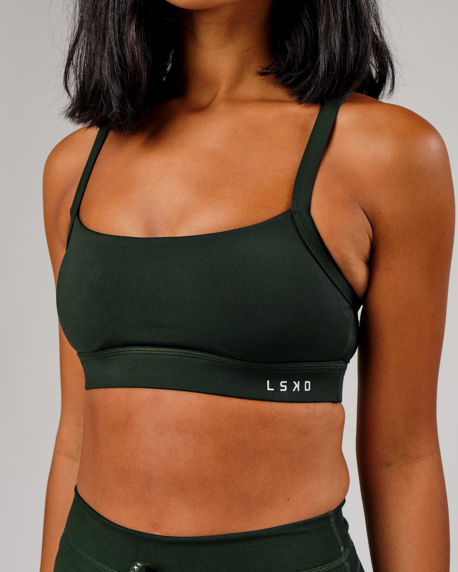 Model wearing Momentum Sports Bra - Forest