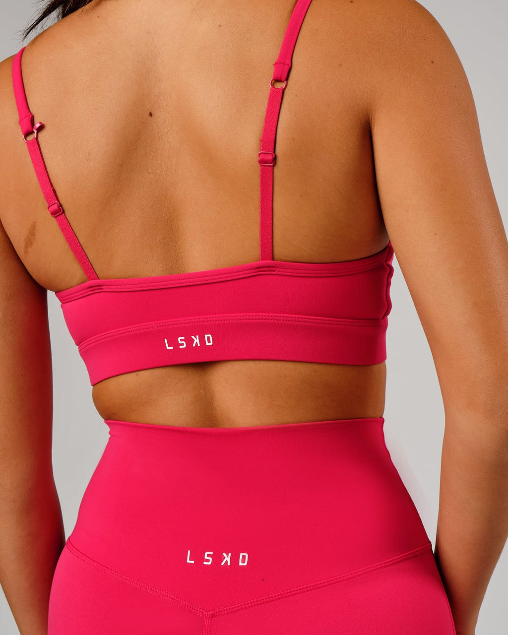 Model wearing Elixir Sports Bra - Boysenberry