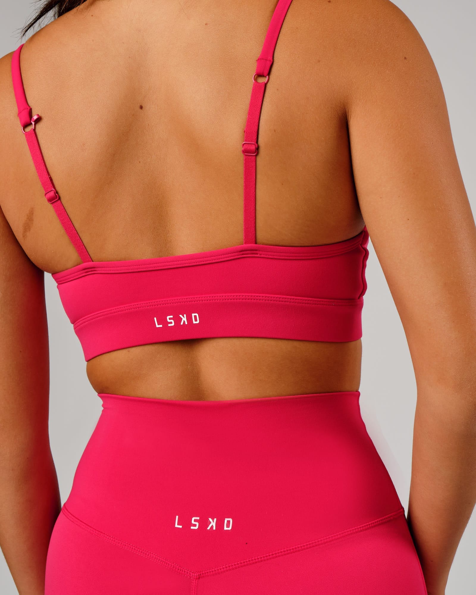 Model wearing Elixir Sports Bra - Boysenberry