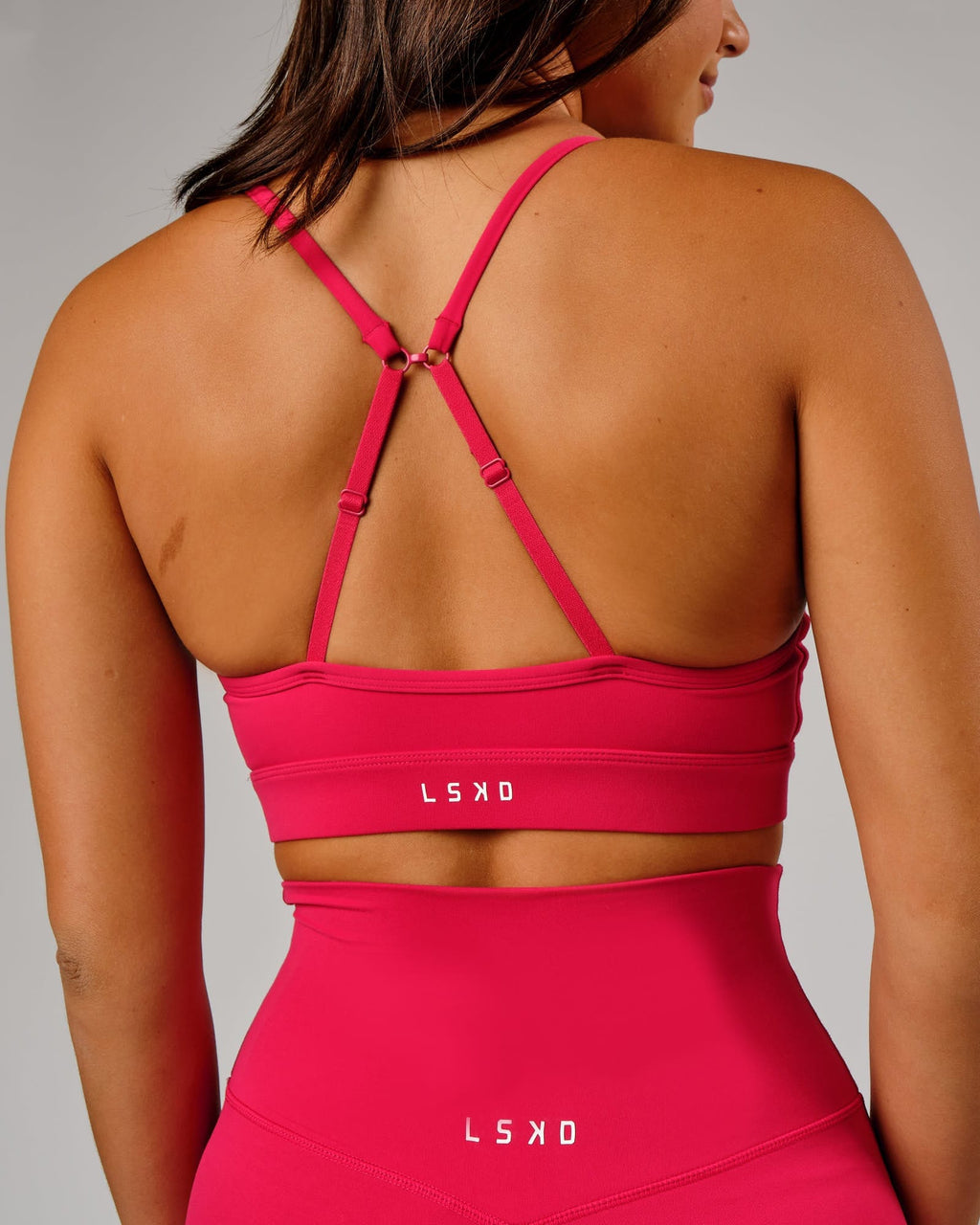 Model wearing Elixir Sports Bra - Boysenberry