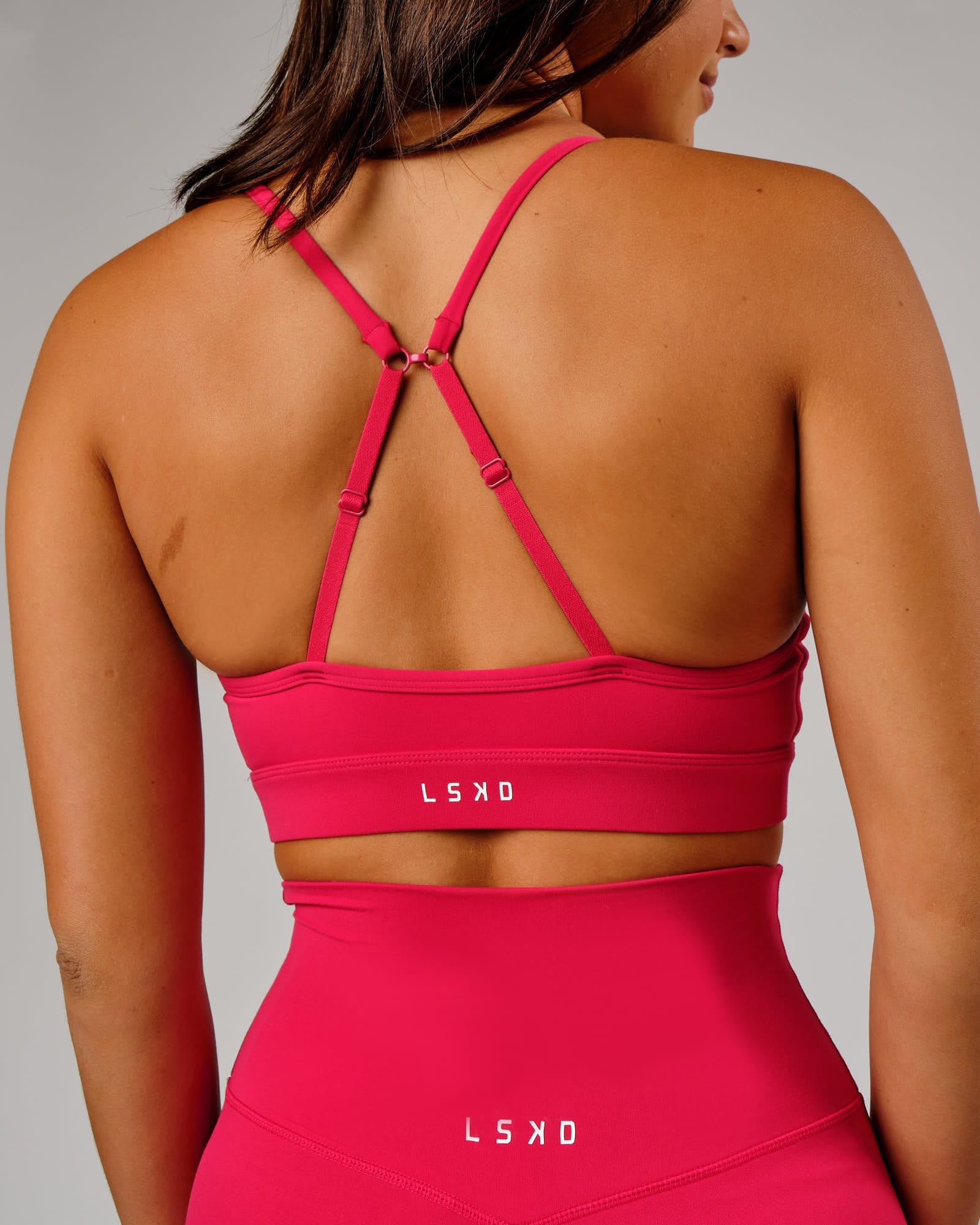 Model wearing Elixir Sports Bra - Boysenberry