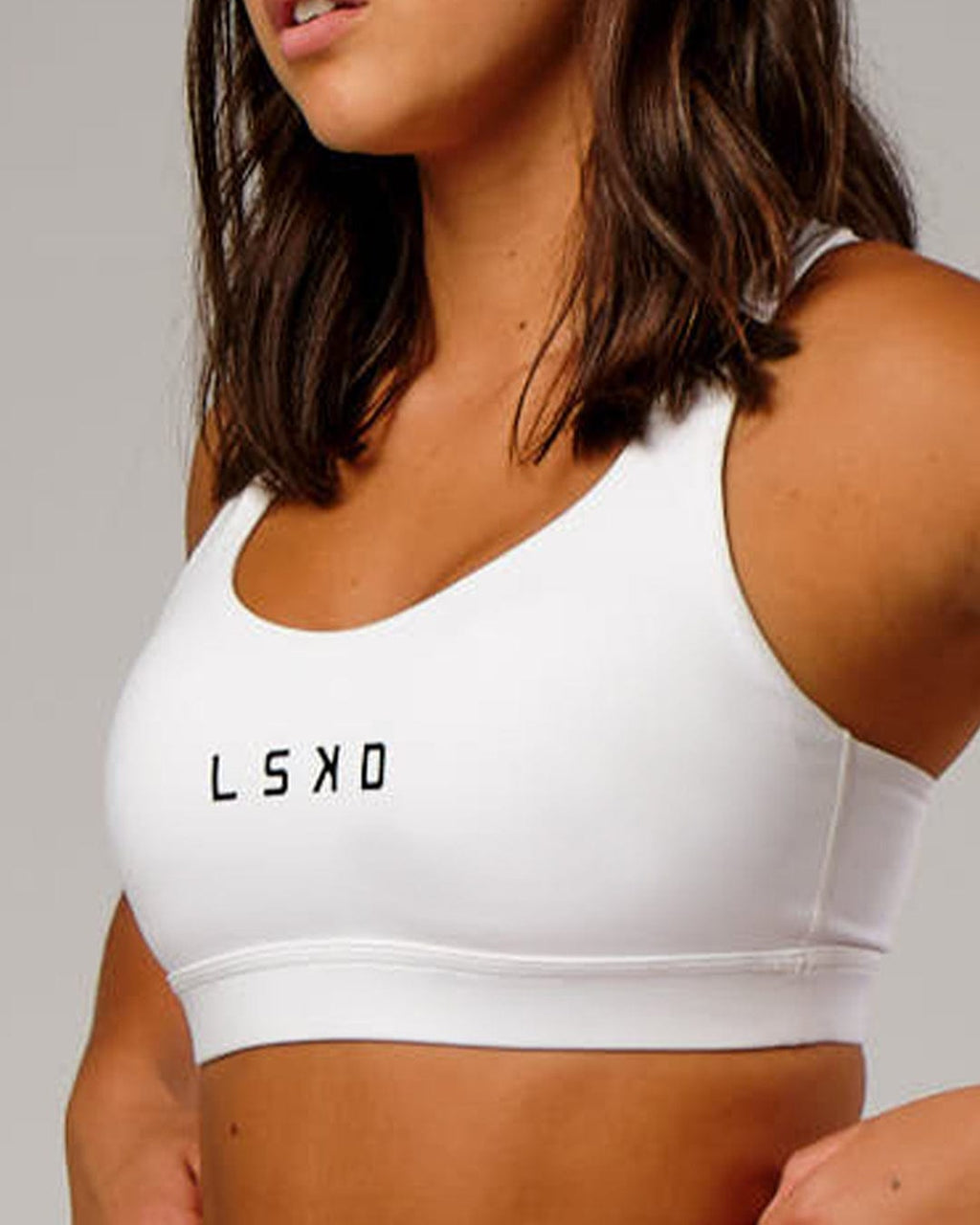 Model wearing Rep Sports Bra Small Logo - White-Black