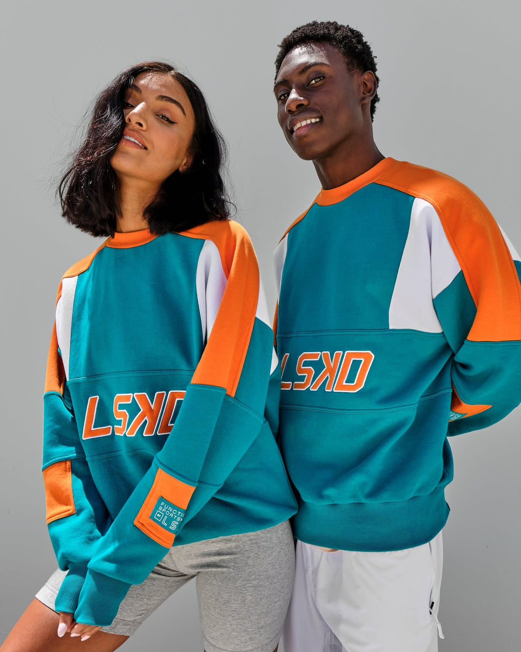 Model wearing Unisex Slam Sweater Oversize - Teal Orange