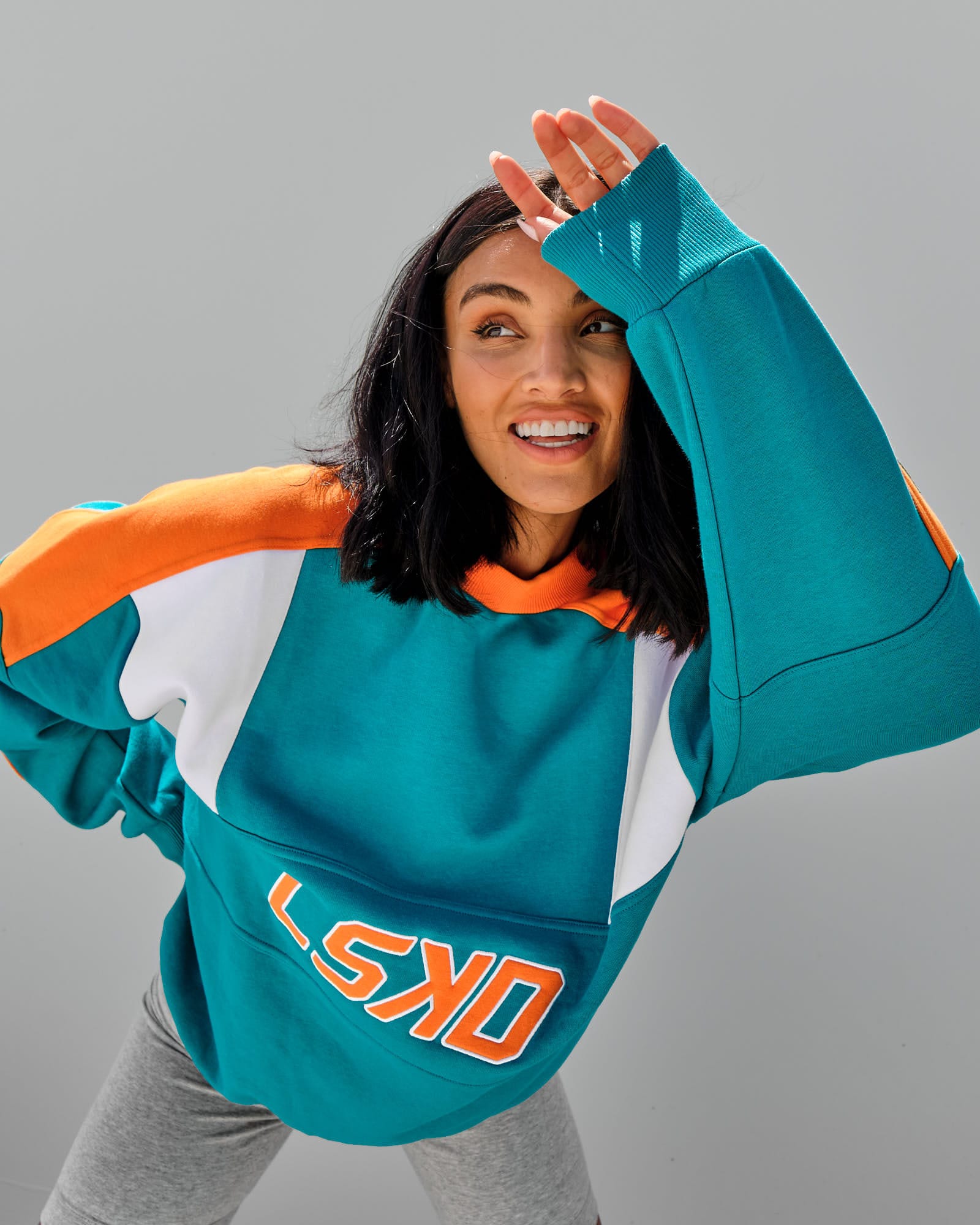 Model wearing Unisex Slam Sweater Oversize - Teal Orange