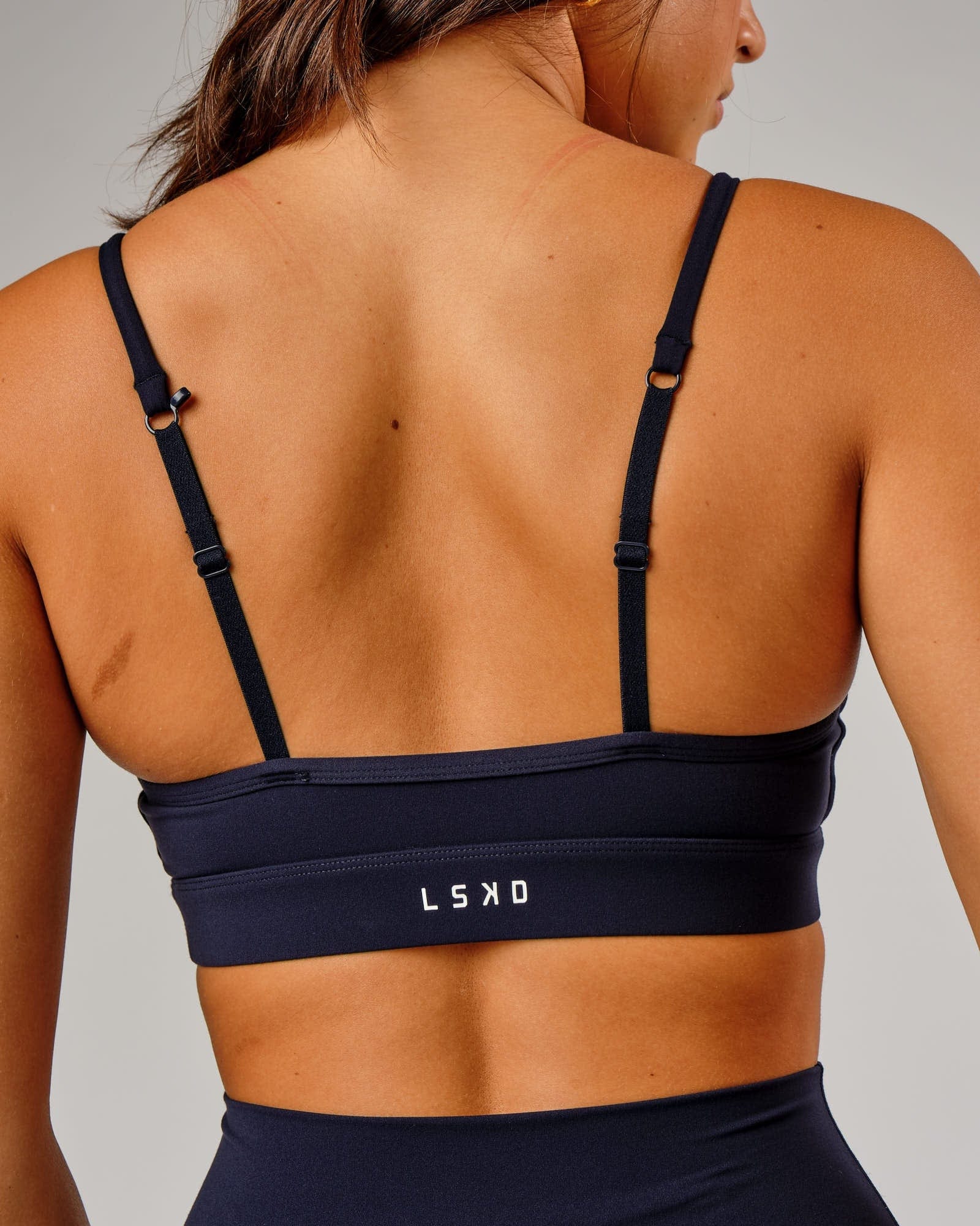 Model wearing Elixir Sports Bra - Navy