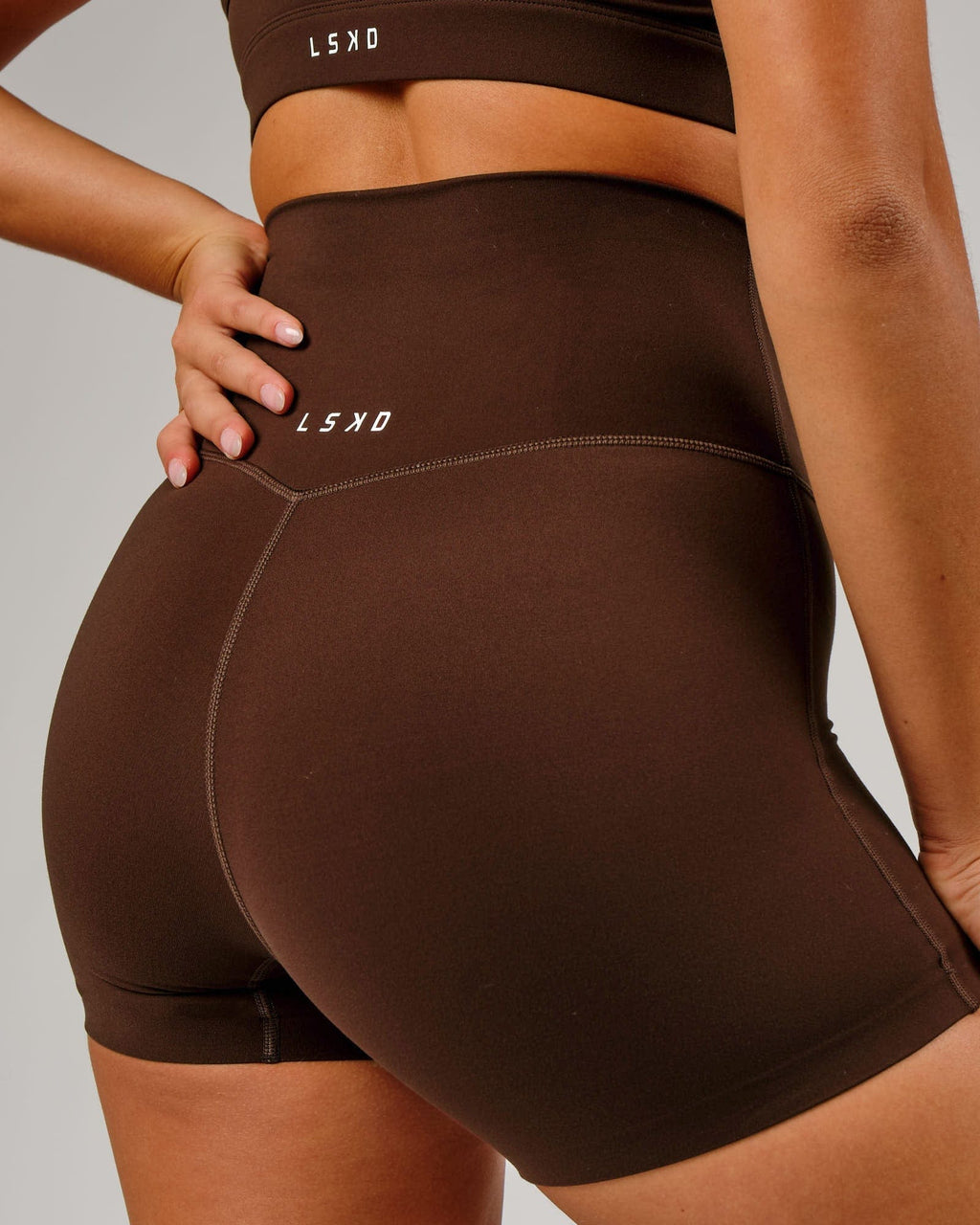 Model wearing Elixir X-Short Tight - Chocolate