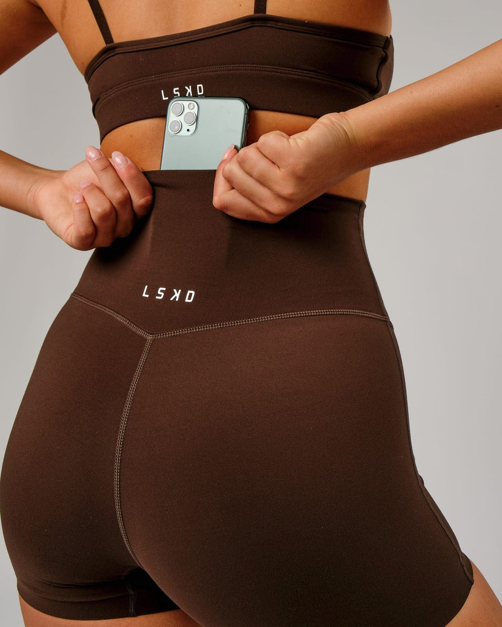 Model wearing Elixir X-Short Tight - Chocolate