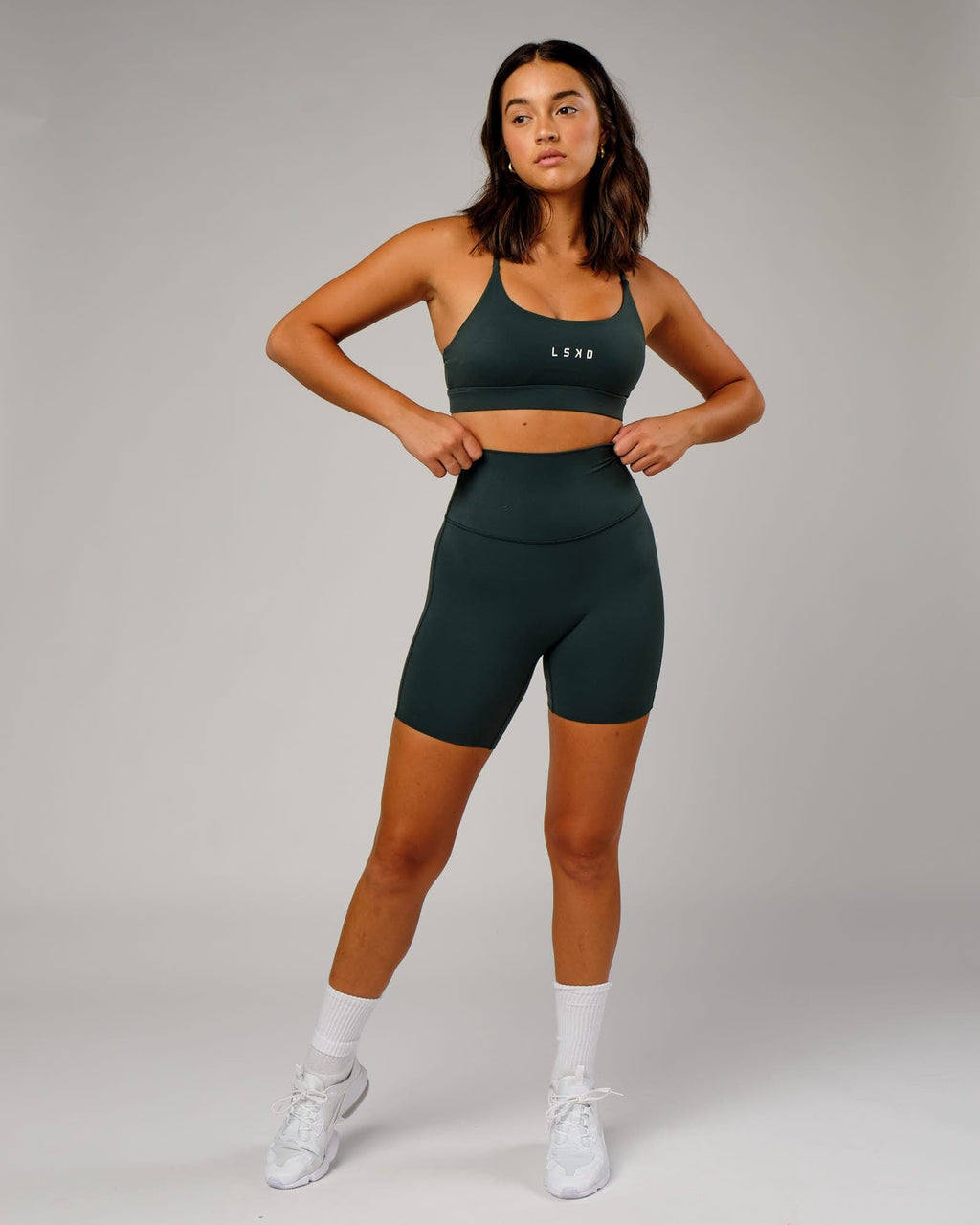 Model wearing Elixir Mid Short Tight - Vital Green