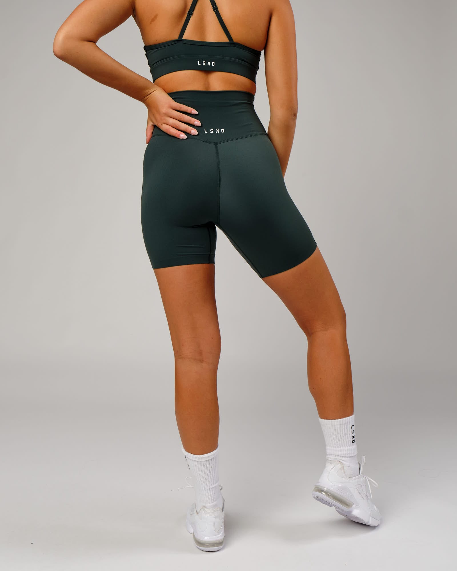 Model wearing Elixir Mid Short Tight - Vital Green