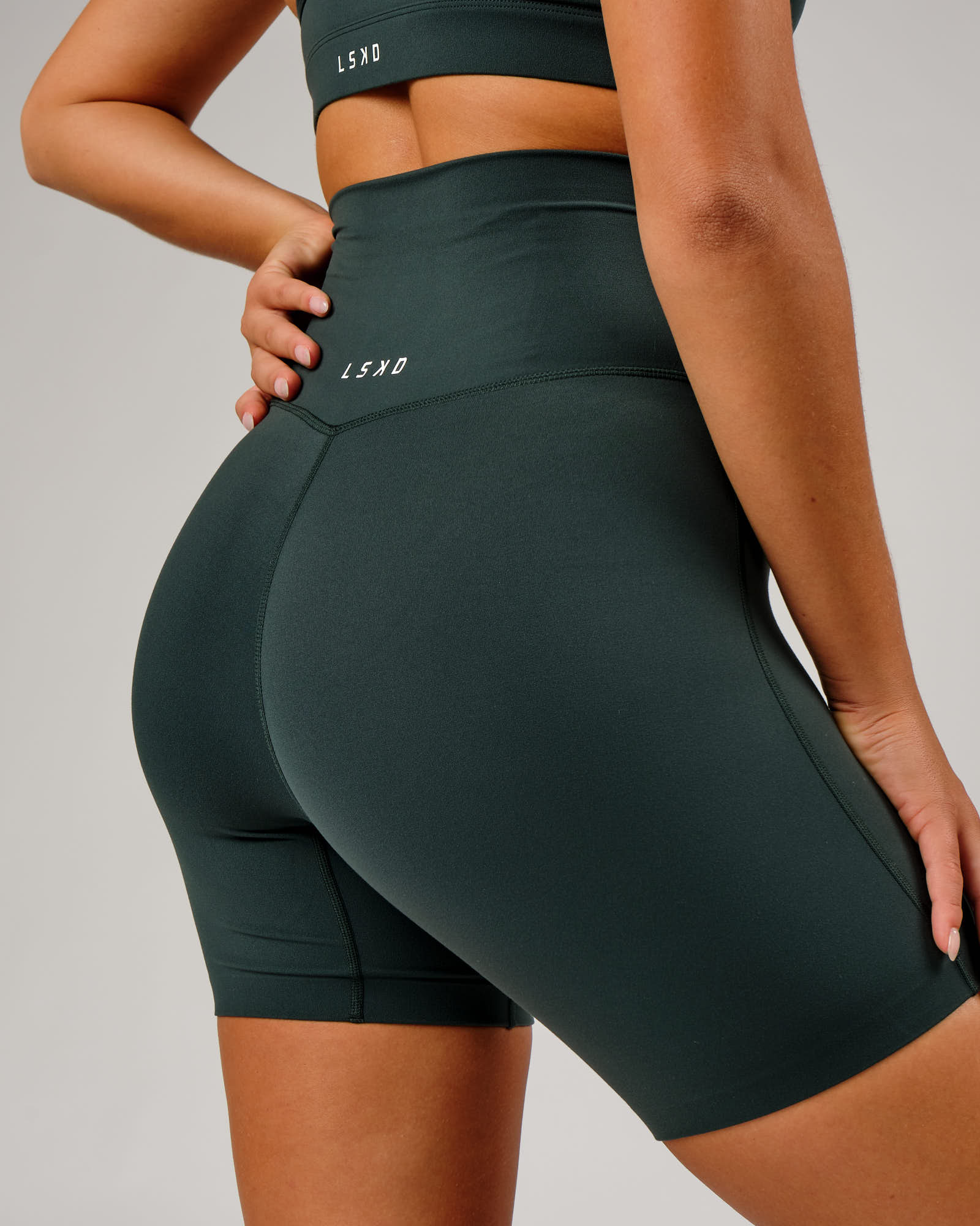 Model wearing Elixir Mid Short Tight - Vital Green