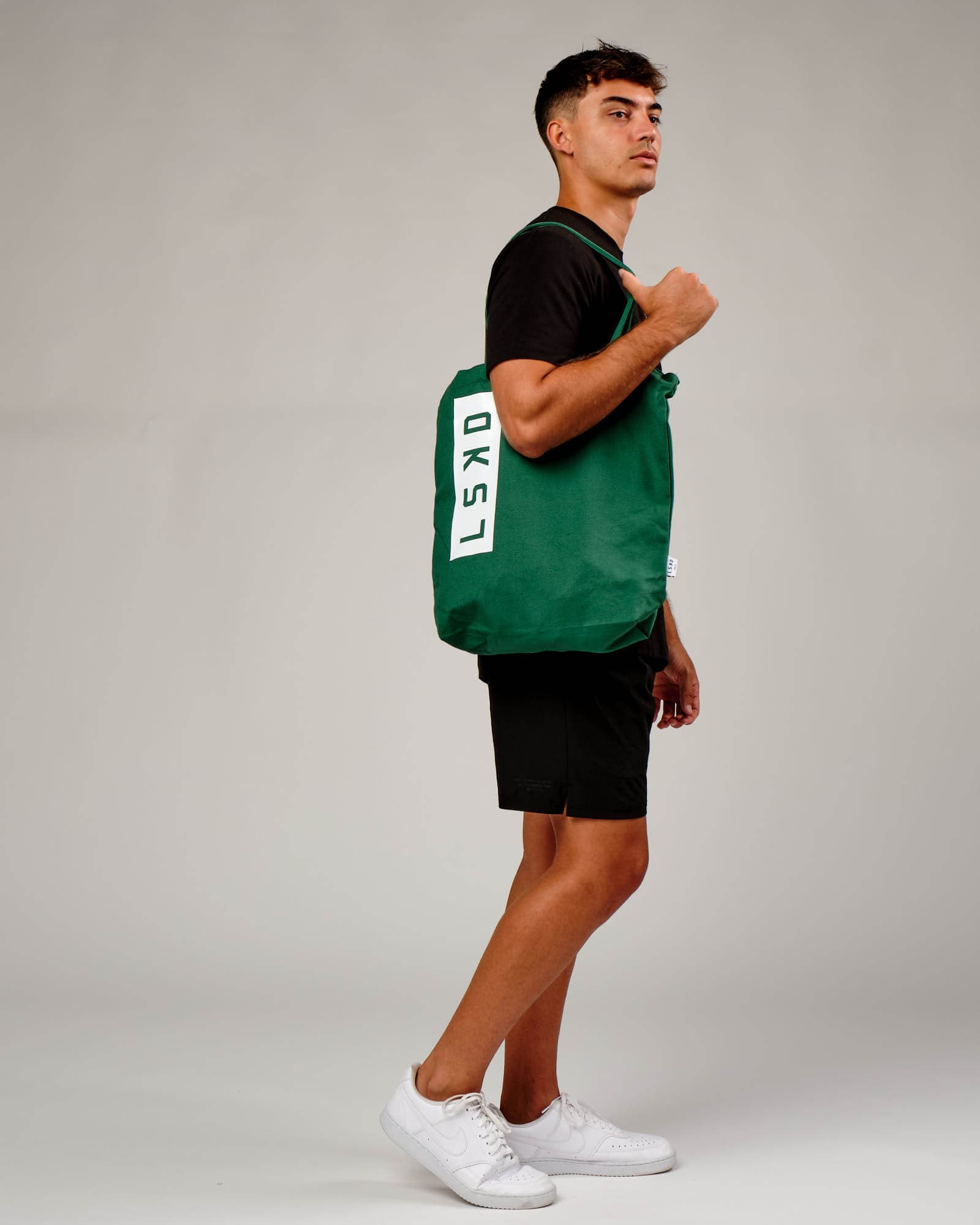 Model wearing Limits Tote Bag - Pine Green