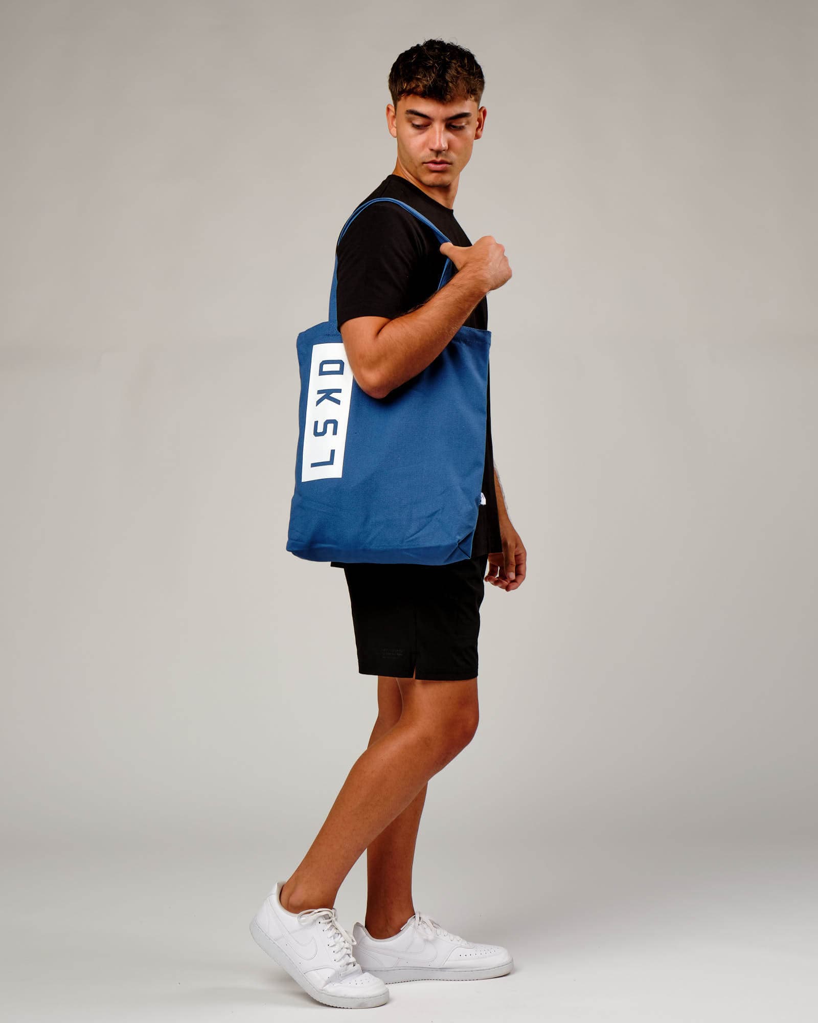 Model wearing Limits Tote Bag - Dusty Cobalt