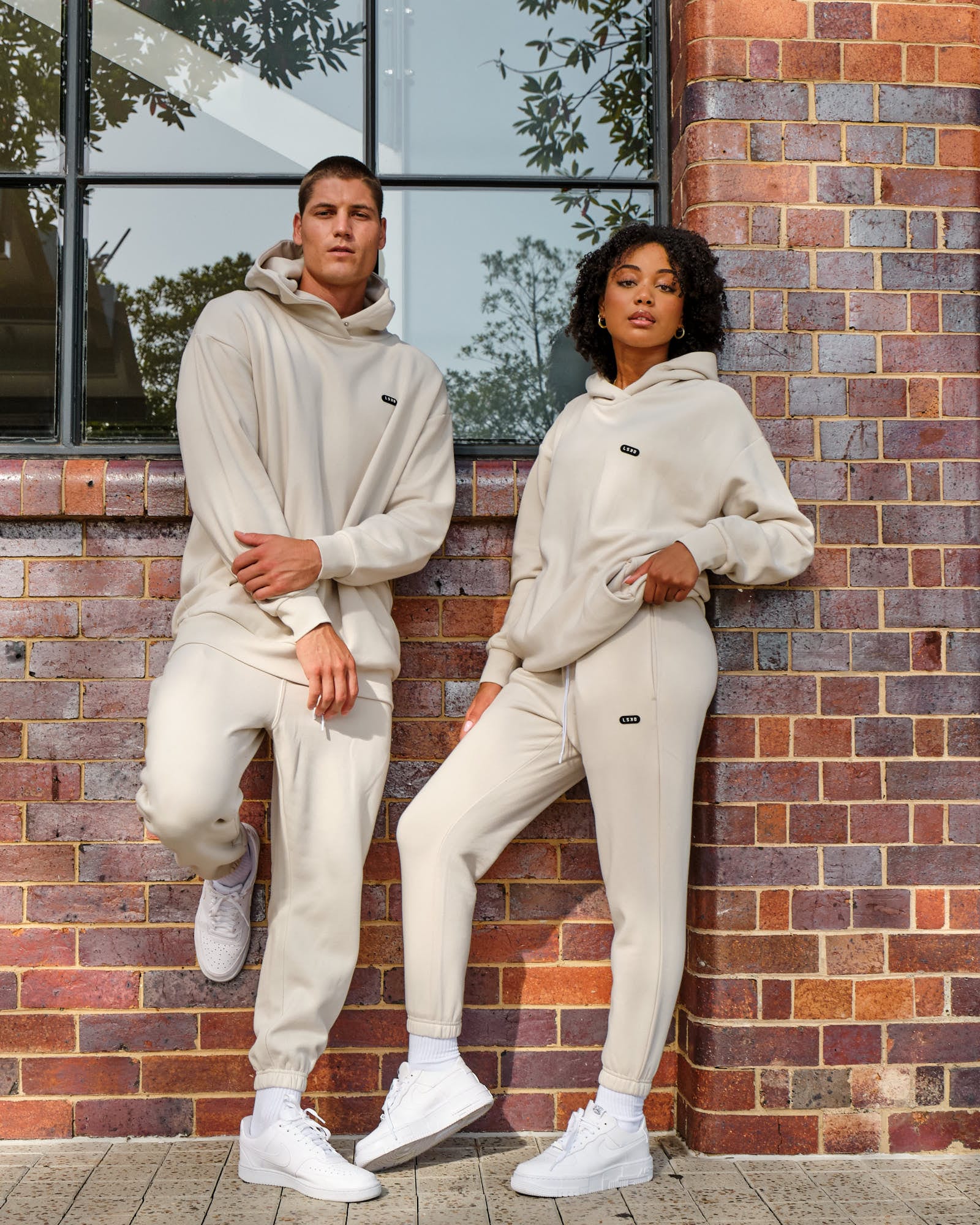 Model wearing Unisex Capsule Track Pant - Bone