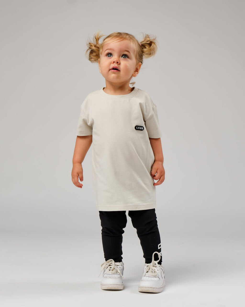 Model wearing Capsule Tee (00-8) - Bone