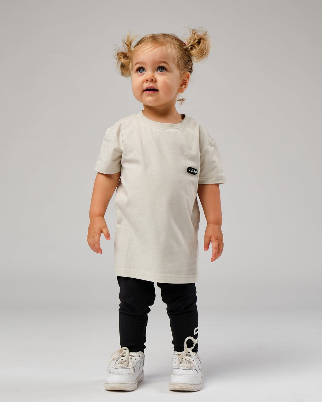 Model wearing Capsule Tee (00-8) - Bone