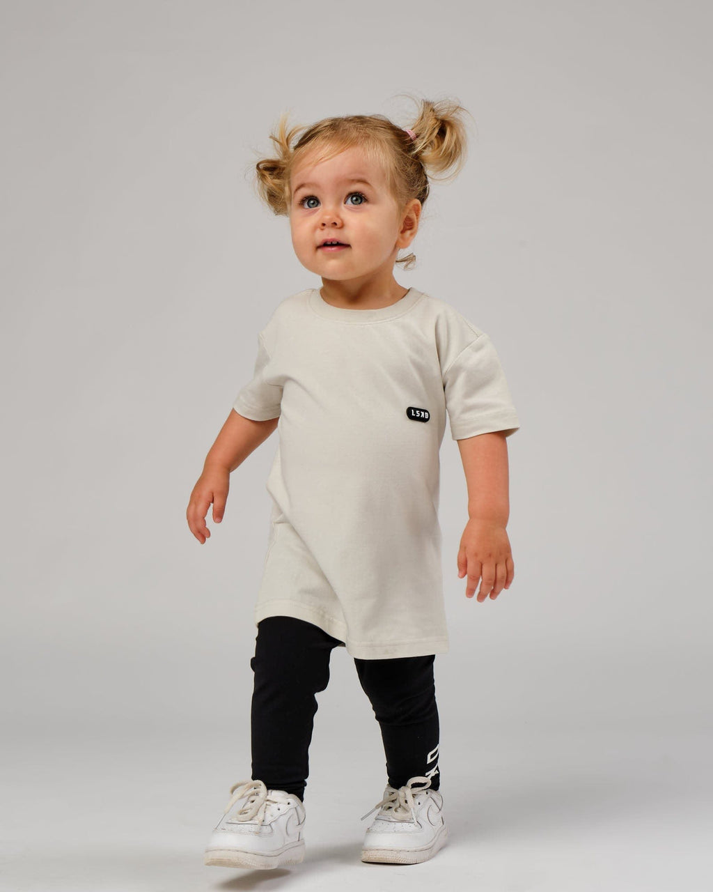 Model wearing Capsule Tee (00-8) - Bone