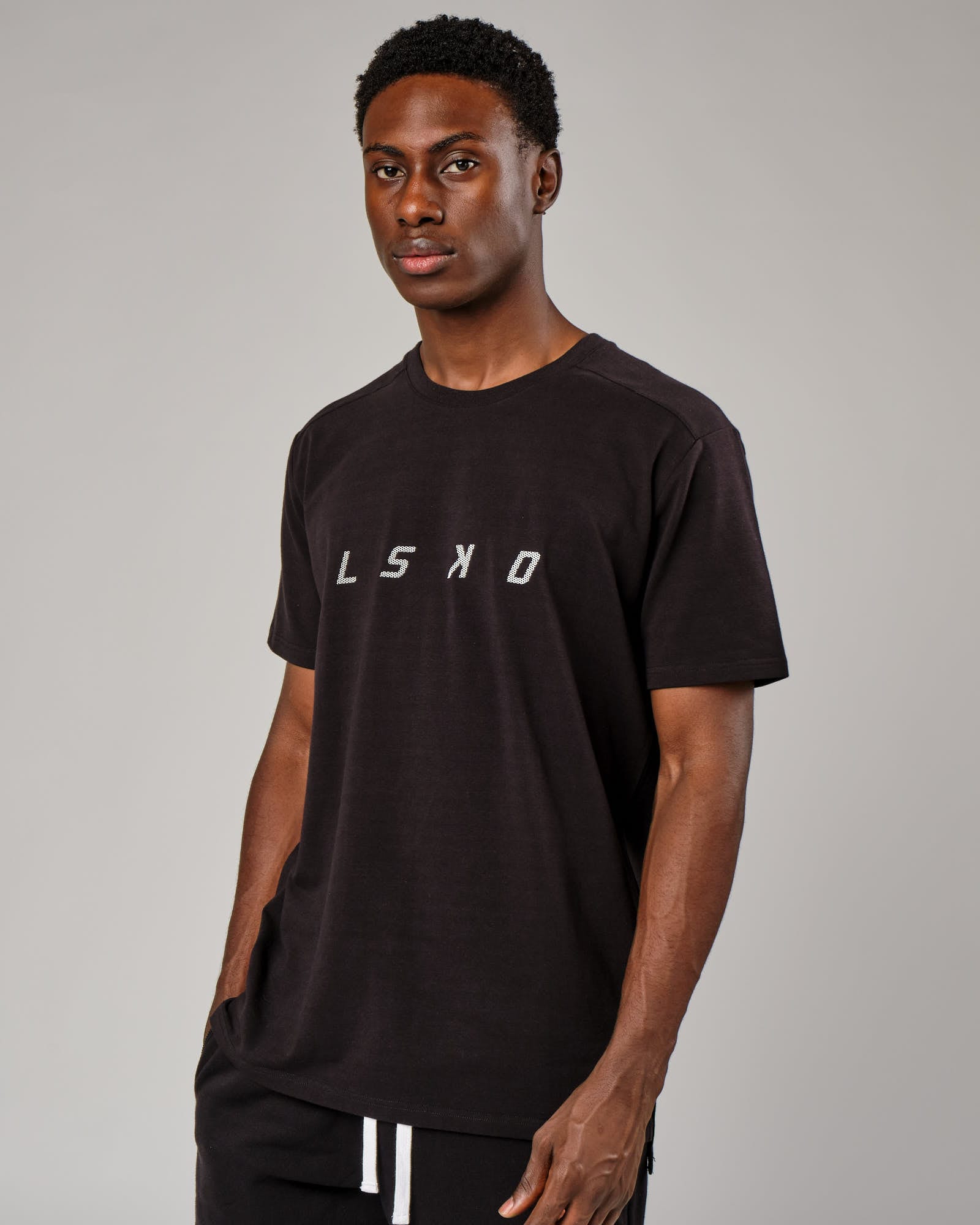Model wearing Grid Tee - Black