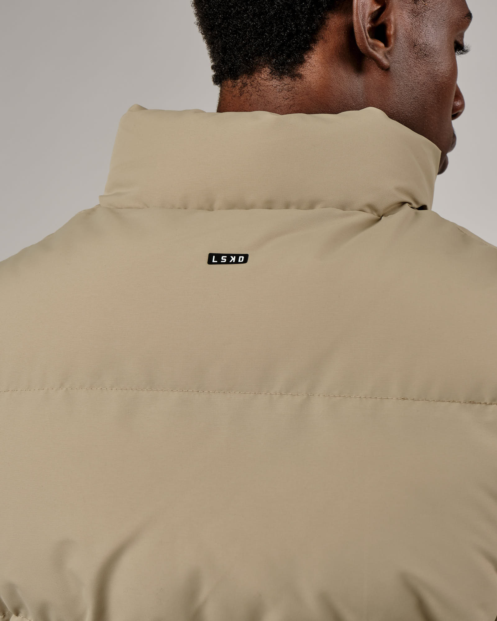 Model wearing Essential Puffer Vest - Laurel Oak