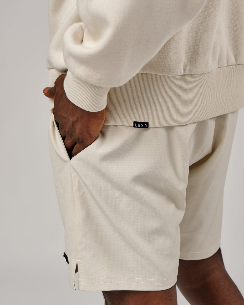 Model wearing Capsule 7" Performance Short - Bone