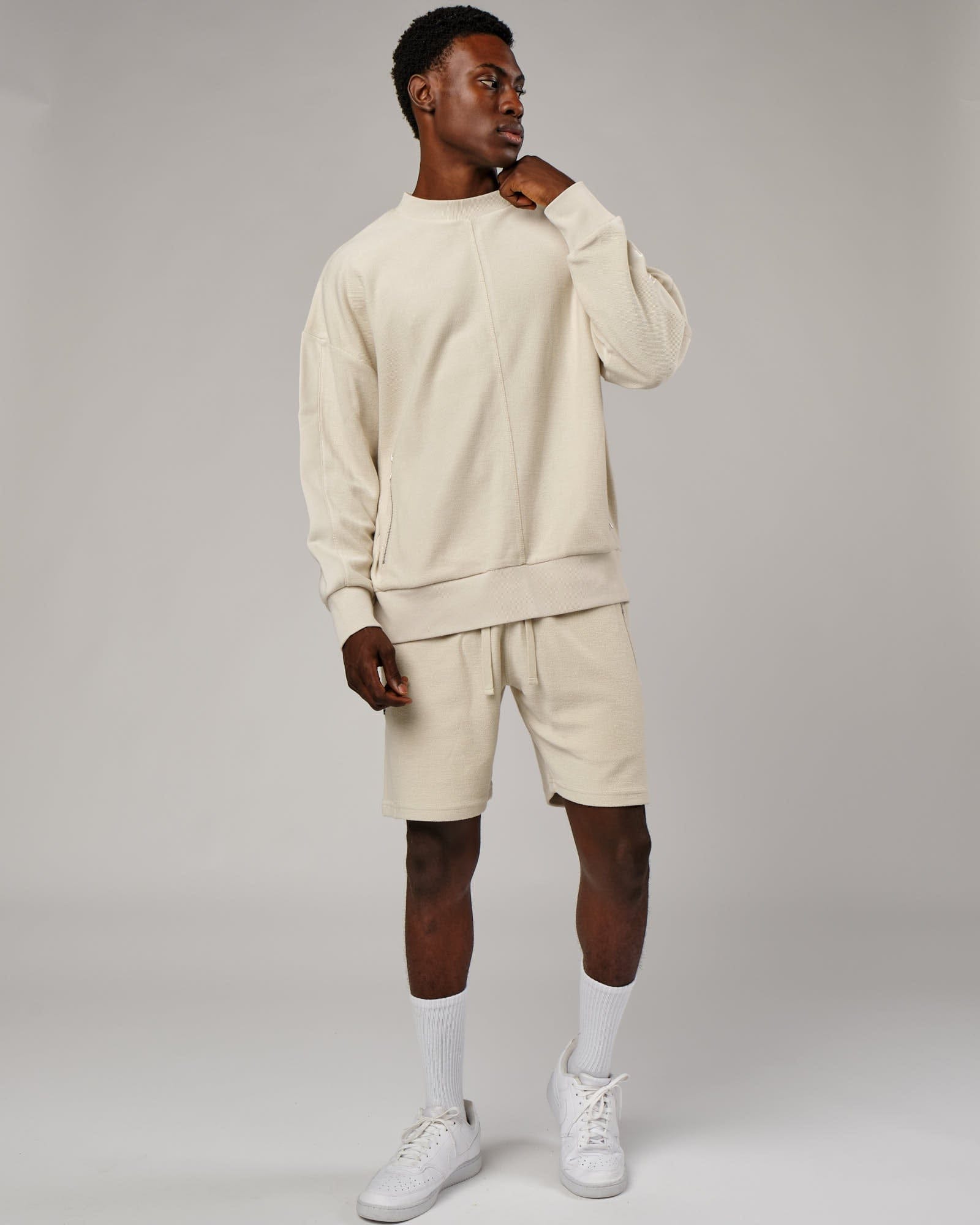 Model wearing Therma Track Short - Bone