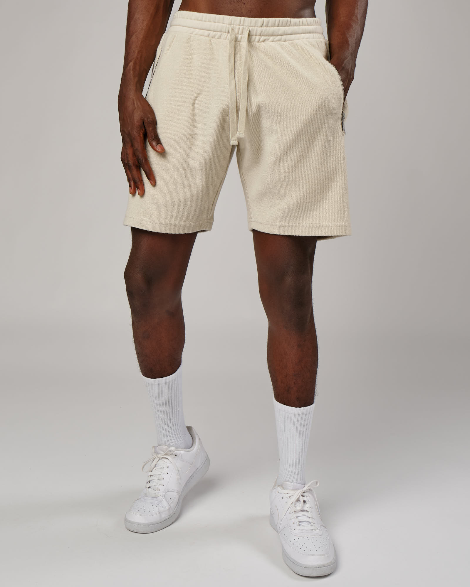 Model wearing Therma Track Short - Bone