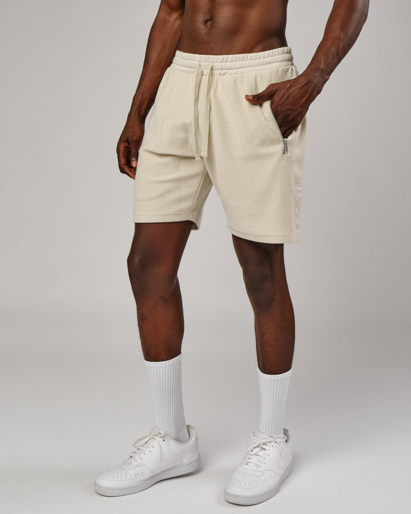 Model wearing Therma Track Short - Bone