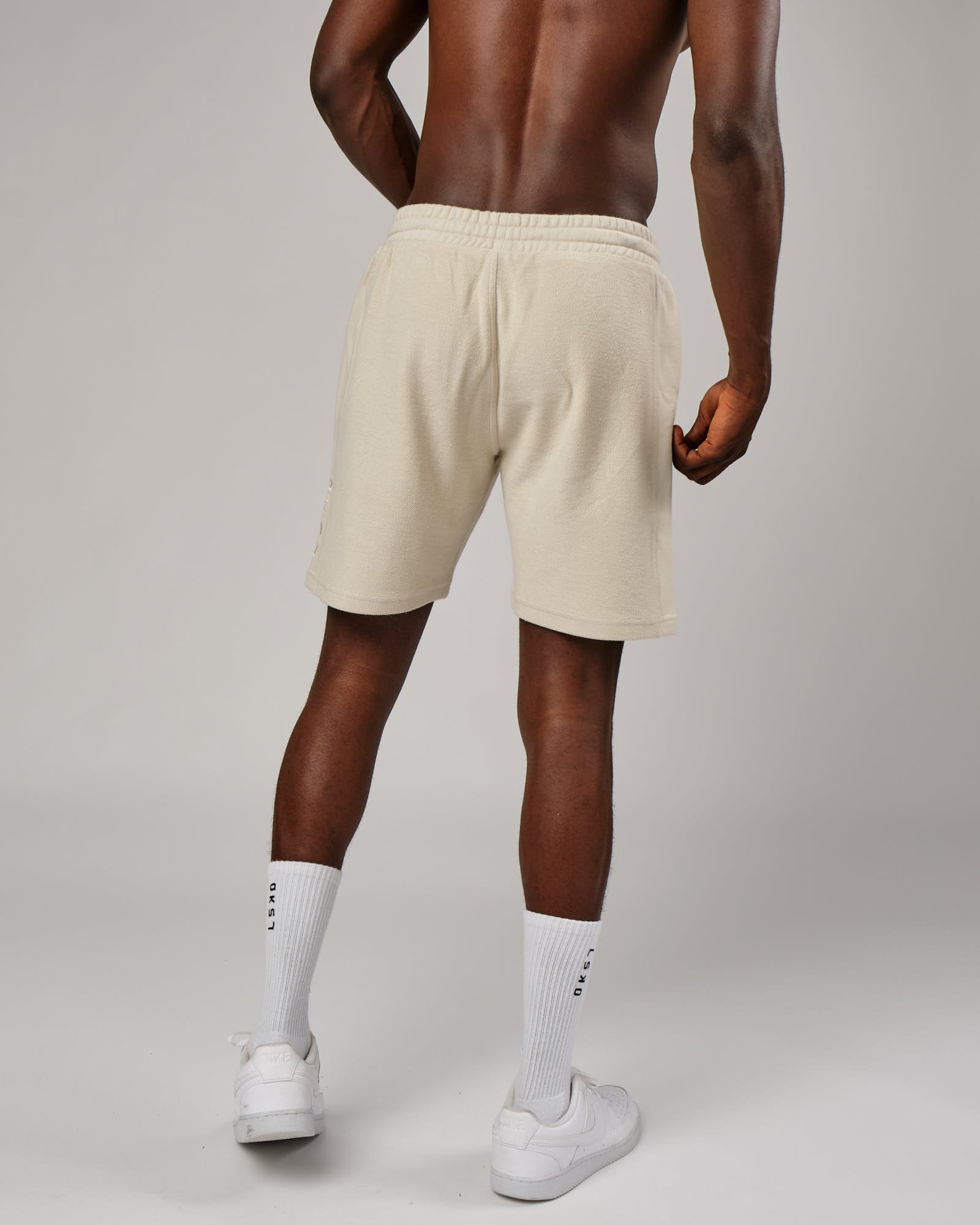 Model wearing Therma Track Short - Bone