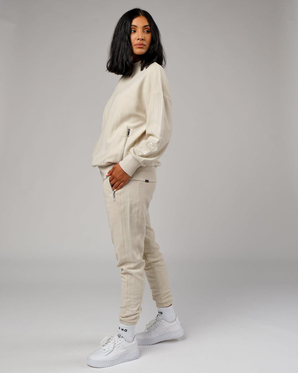 Model wearing Unisex Therma Track Pant - Bone