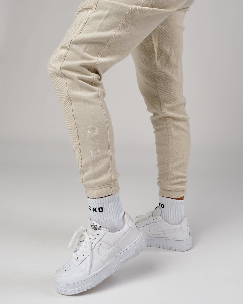 Model wearing Unisex Therma Track Pant - Bone