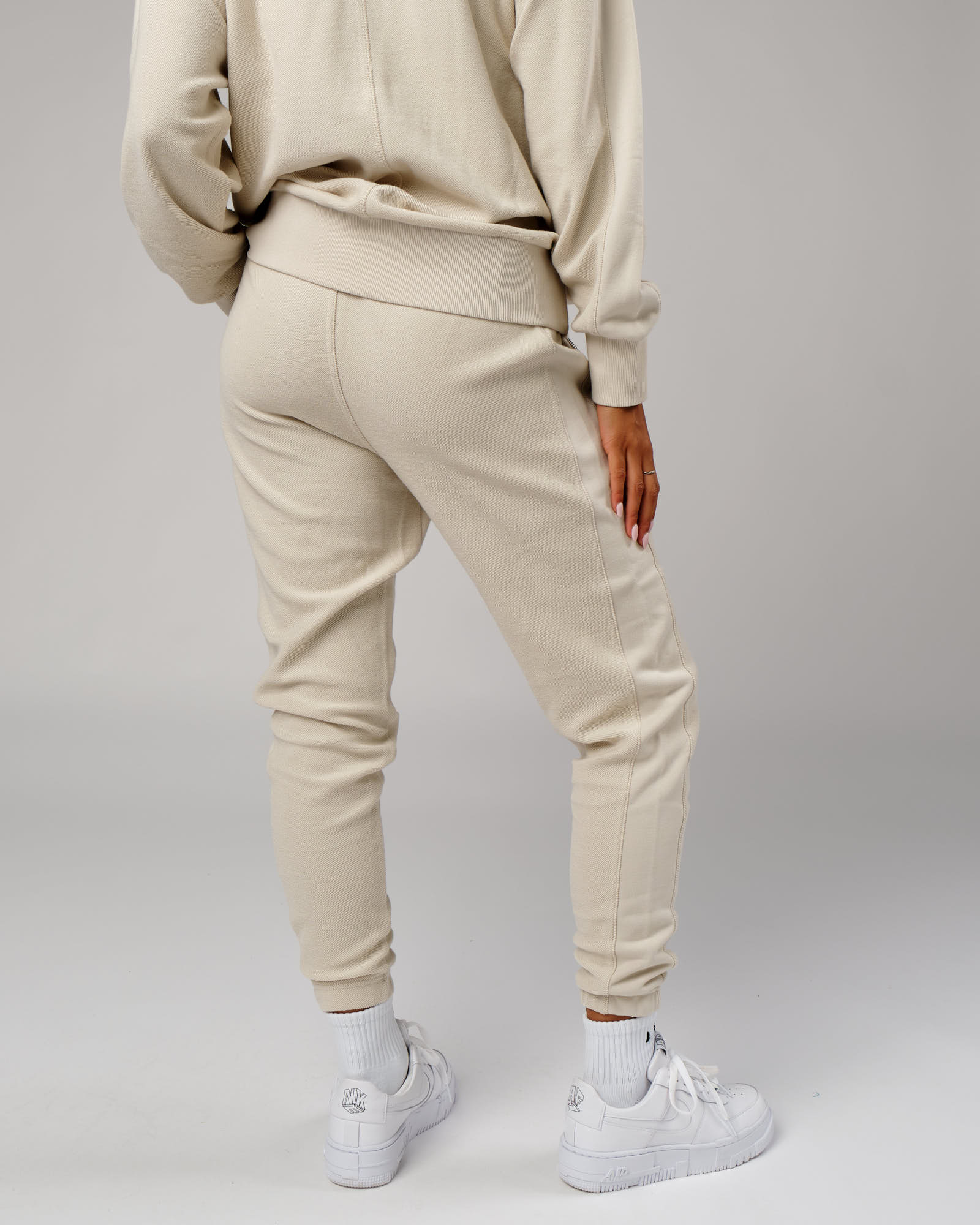 Model wearing Unisex Therma Track Pant - Bone