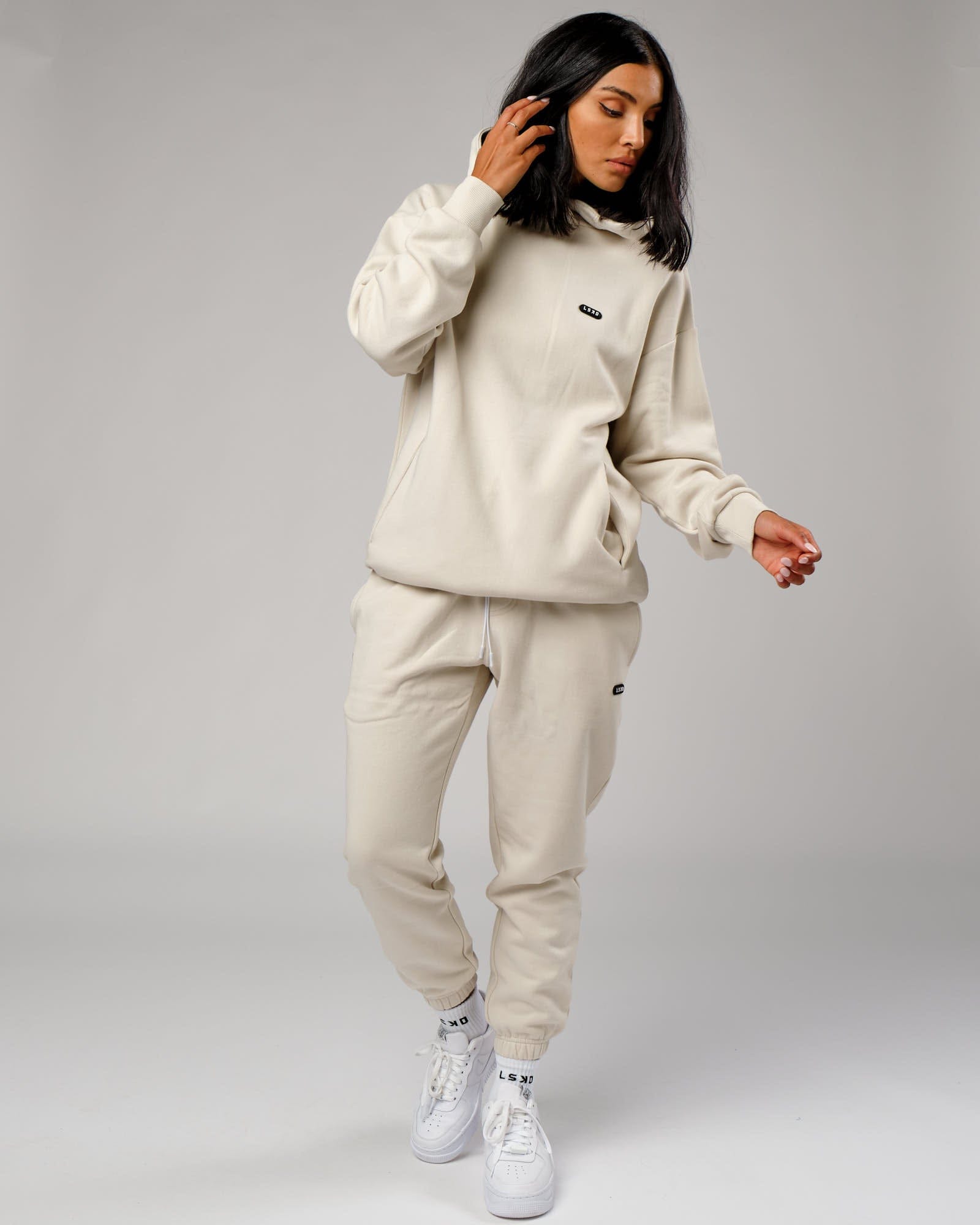 Model wearing Unisex Capsule Track Pant - Bone