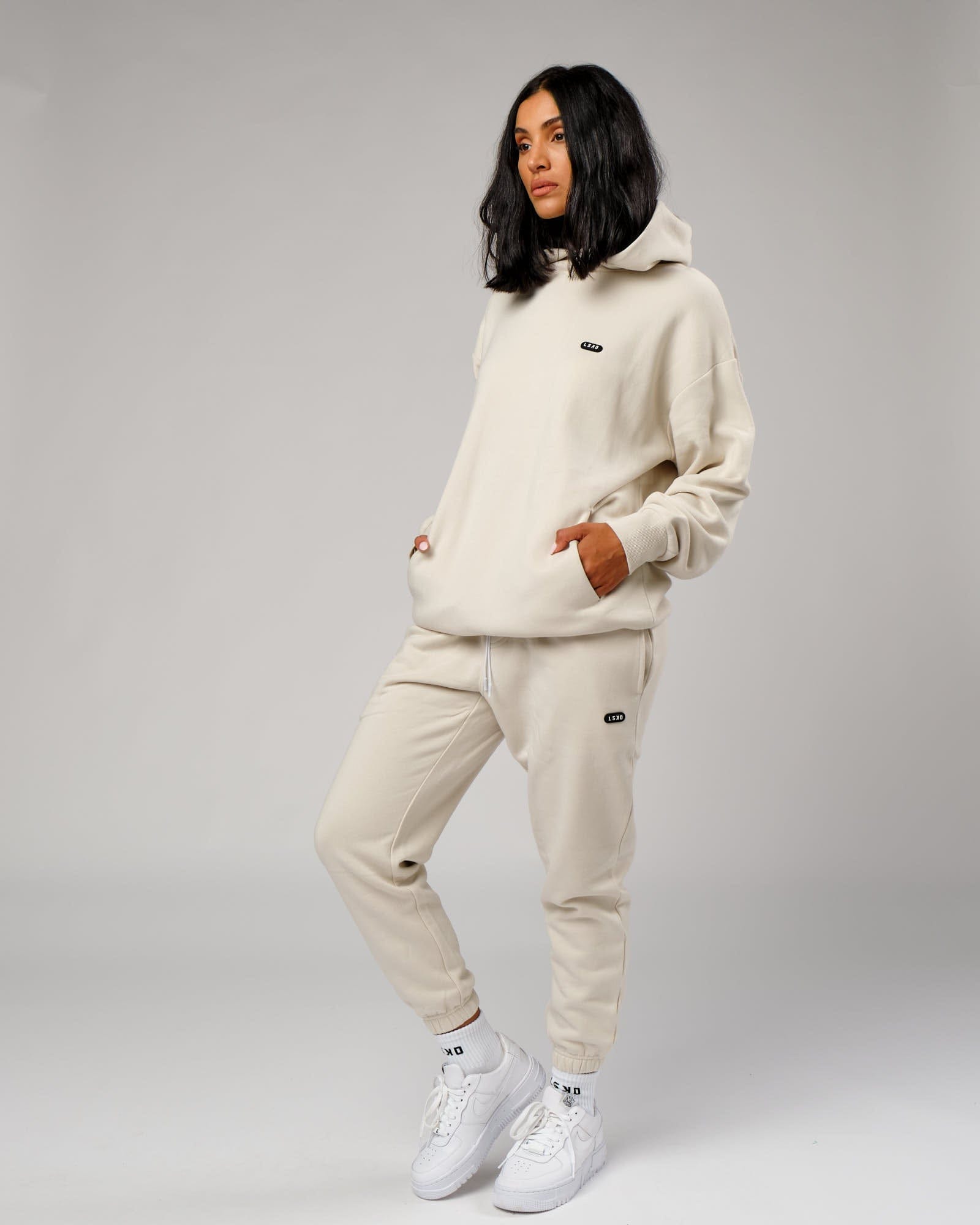 Model wearing Unisex Capsule Track Pant - Bone