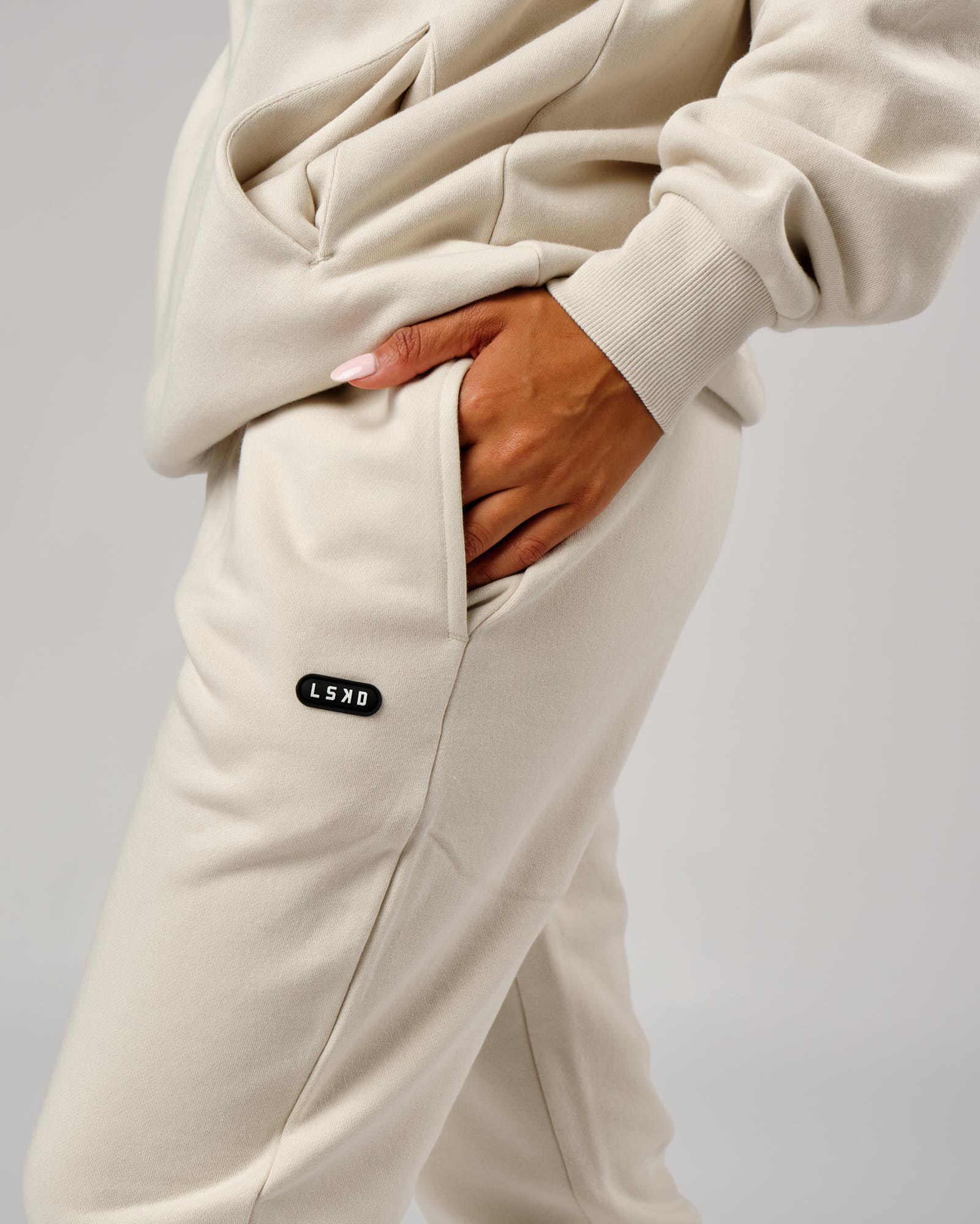 Model wearing Unisex Capsule Track Pant - Bone