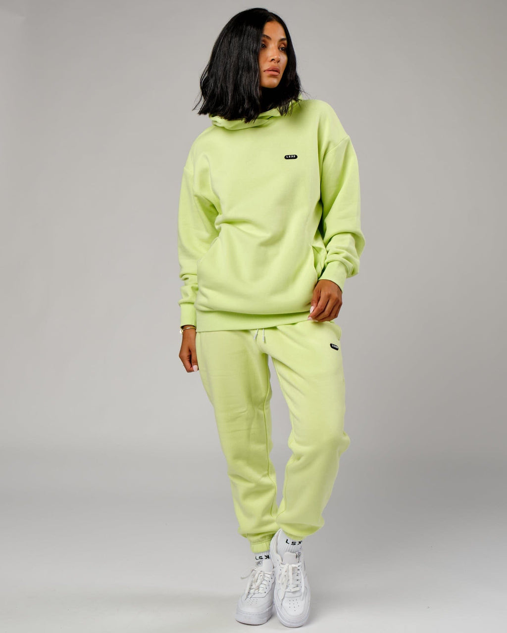 Model wearing Unisex Capsule Track Pant - Pastel Lime