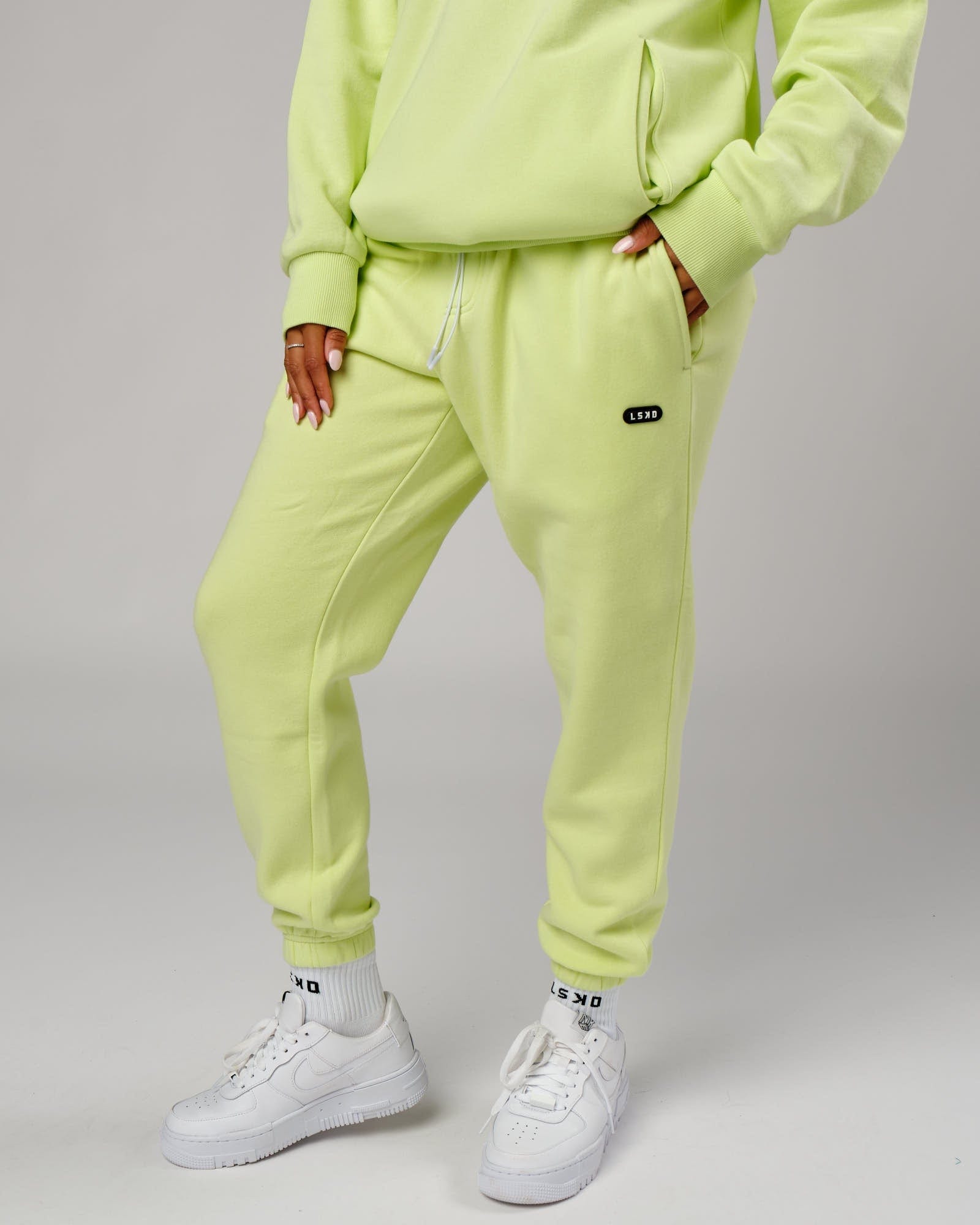 Model wearing Unisex Capsule Track Pant - Pastel Lime