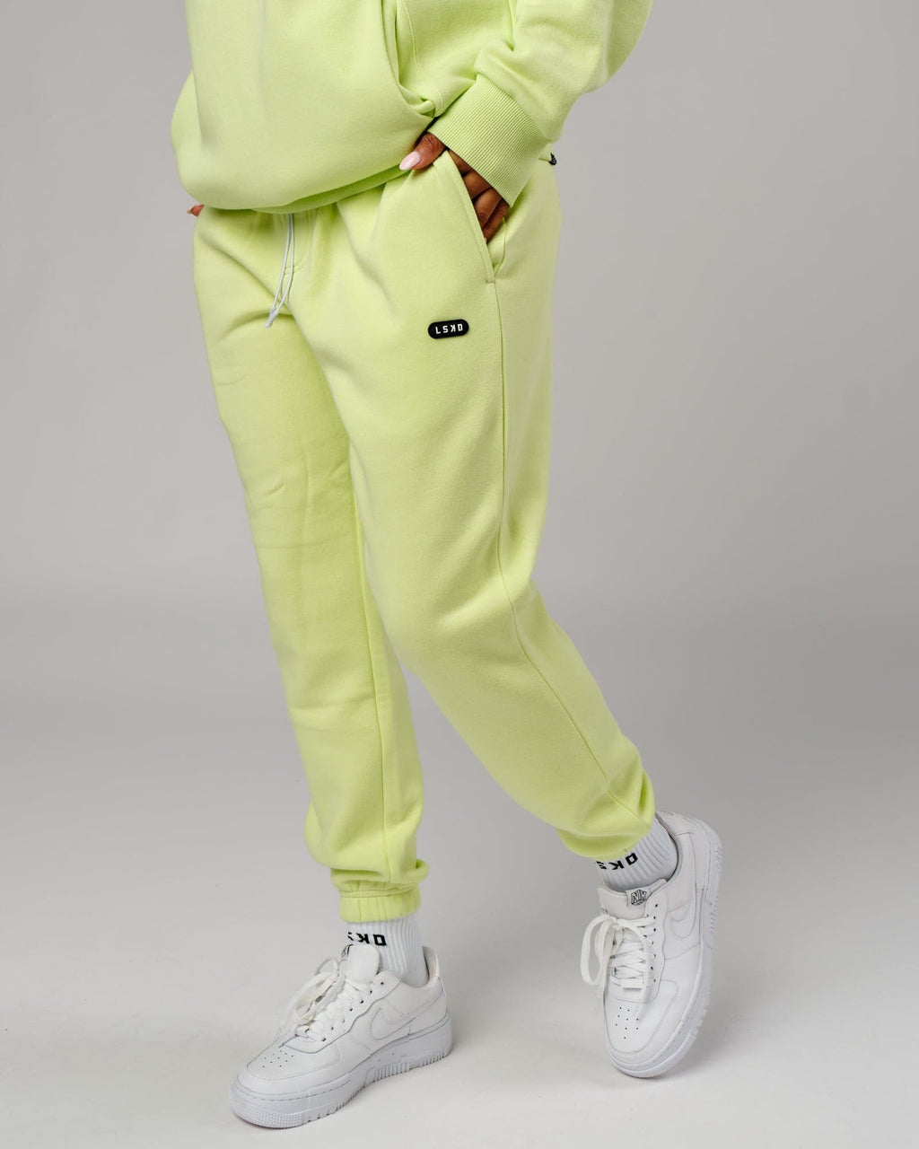 Model wearing Unisex Capsule Track Pant - Pastel Lime