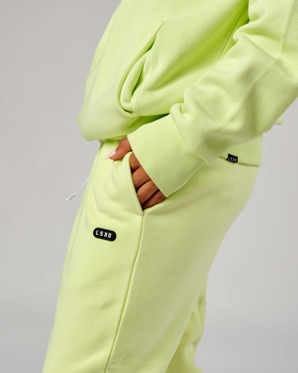 Model wearing Unisex Capsule Track Pant - Pastel Lime