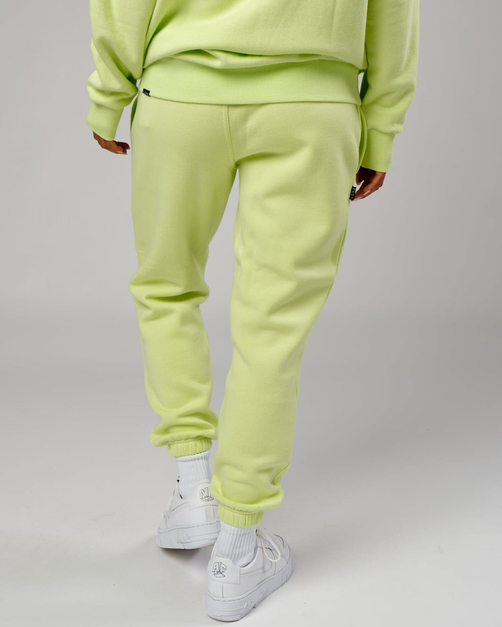 Model wearing Unisex Capsule Track Pant - Pastel Lime