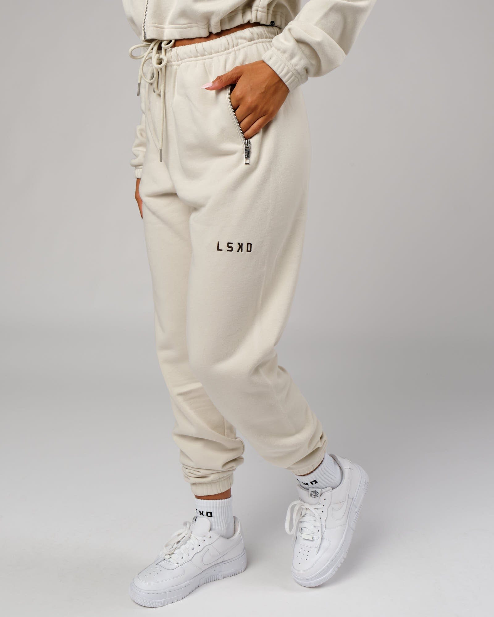 Model wearing Bridge Track Pant - Bone