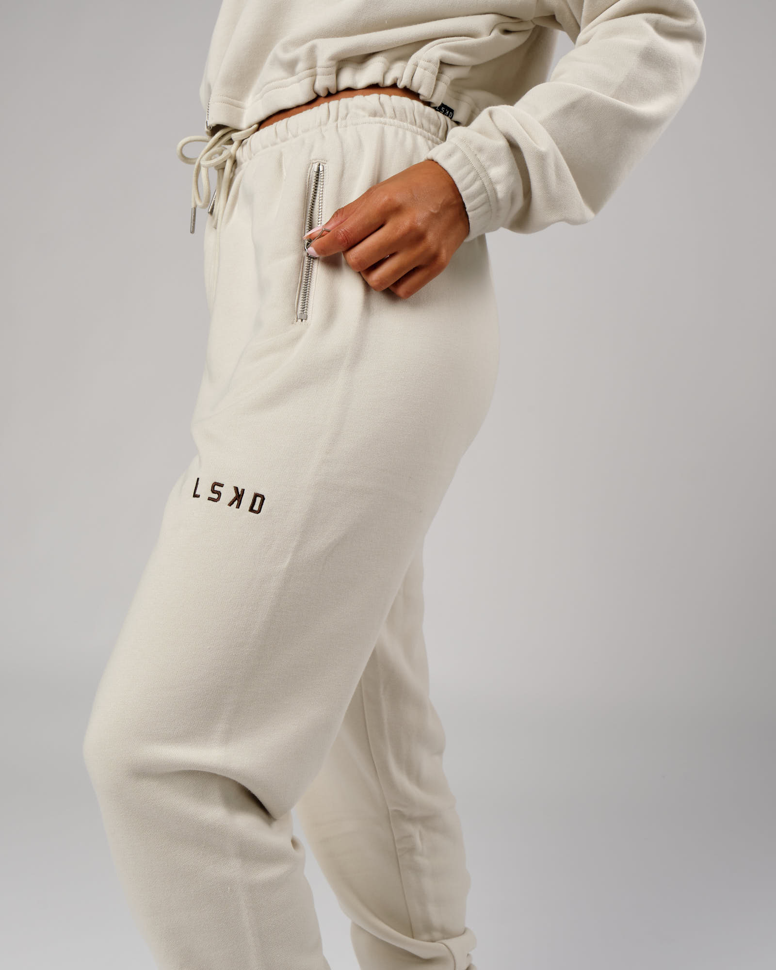 Model wearing Bridge Track Pant - Bone
