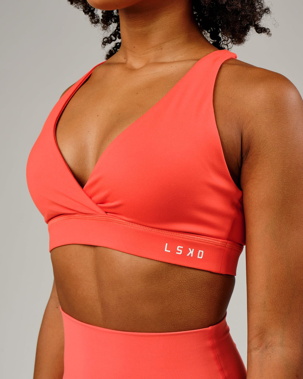 Model wearing Ignite Sports Bra - Fruit Punch
