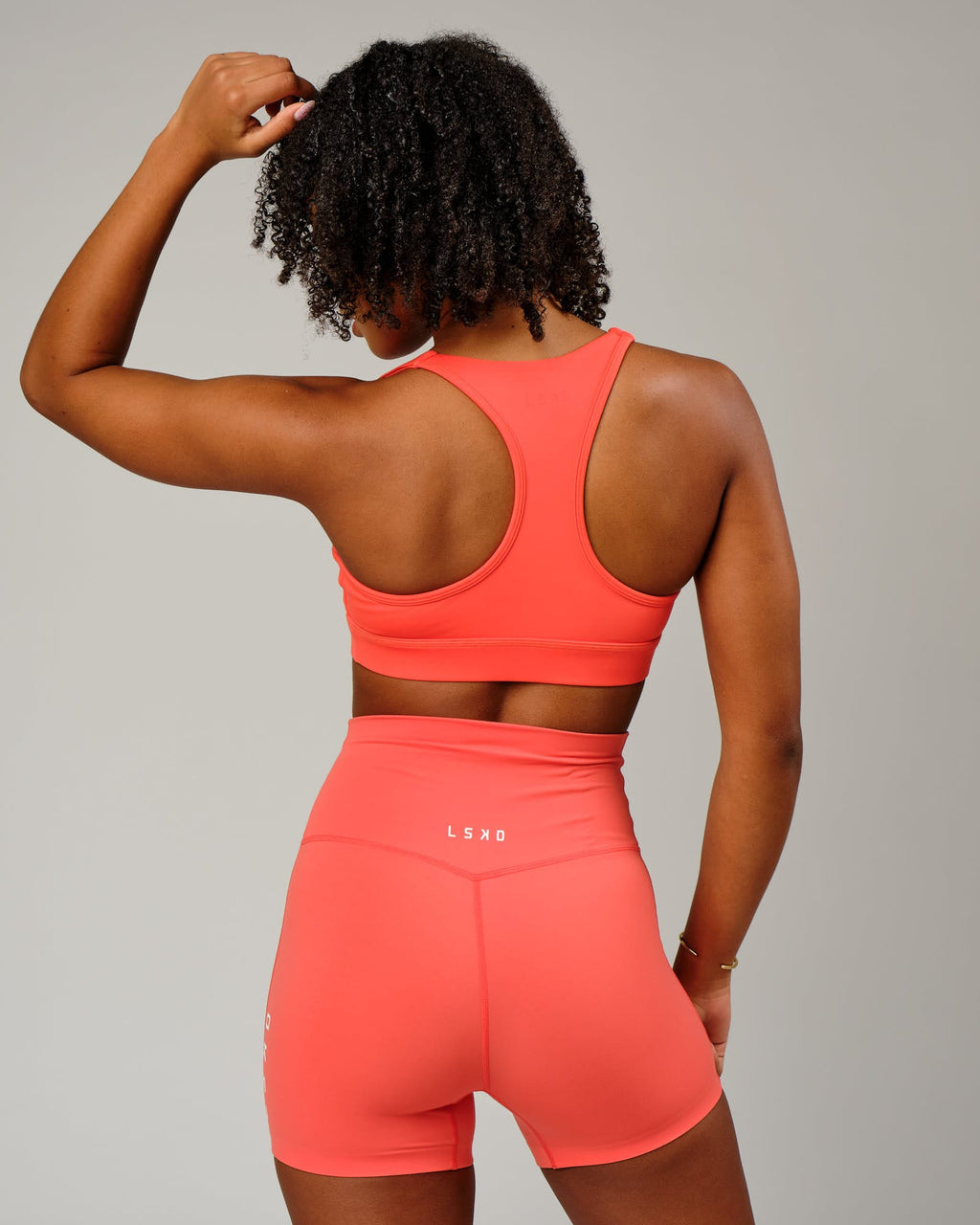 Model wearing Ignite Sports Bra - Fruit Punch