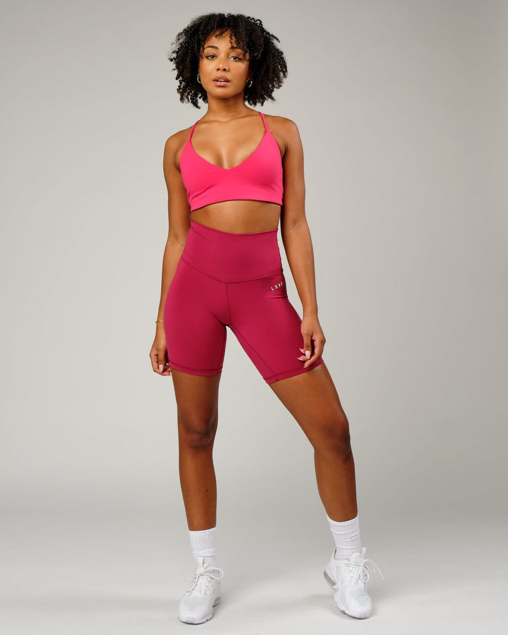 Model wearing Base Mid Short Tight - Candy Apple